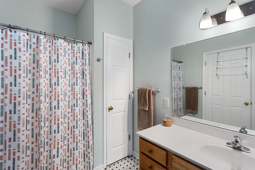 with linen closet, walk-in shower & grab bars.