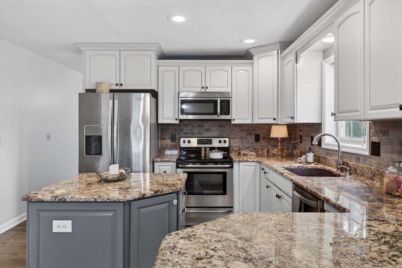 *the kitchen has been updated and includes granite countertops, a tile backsplash and island
