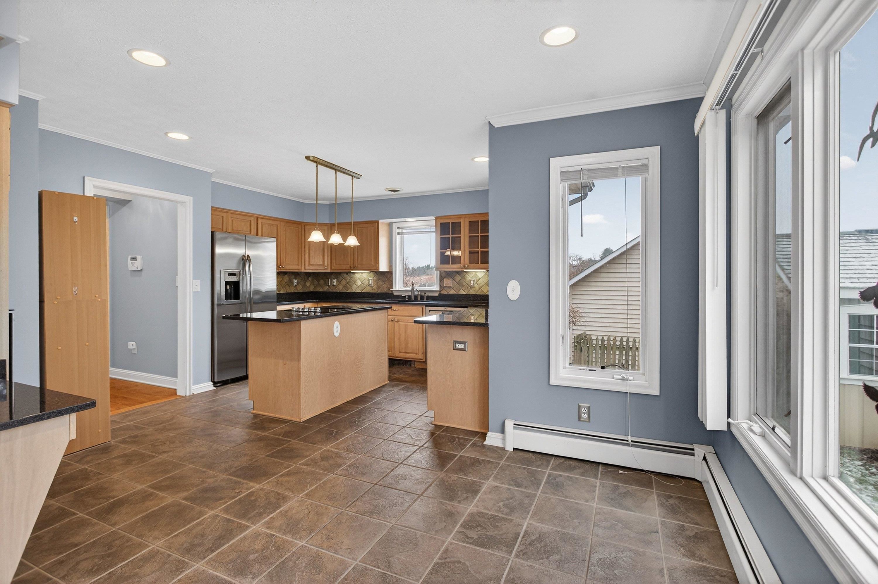 This large dining area is located off the kitchen space.  This room offers tile flooring throughout, recessed lighting, and offers multiple windows allowing in an abundance of natural light.