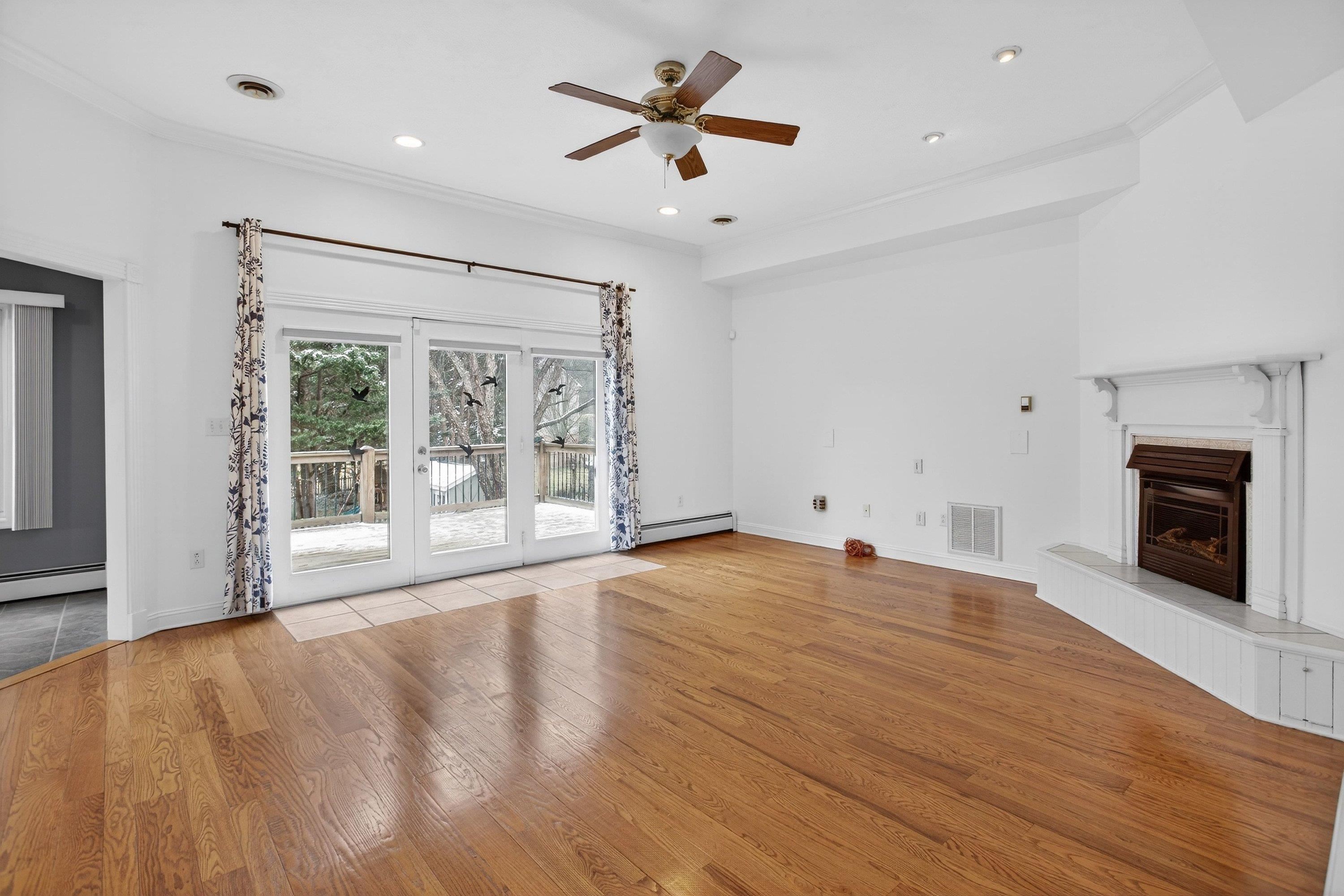 The living room offers a vaulted ceiling and hardwood treads throughout.  This space also features a gas fireplace, ceiling fan, and a large space with a lot of natural light throughout.
