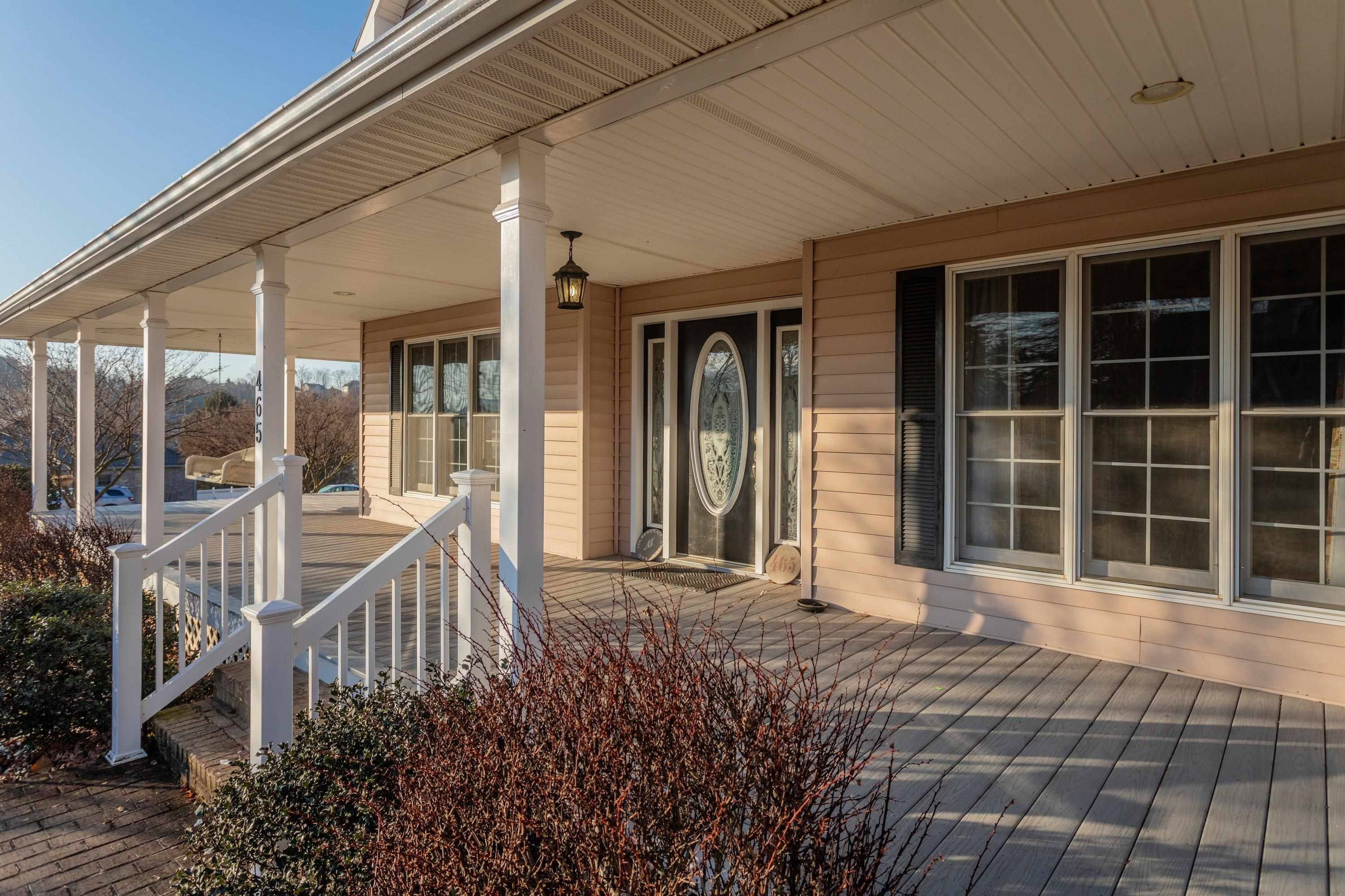 The front porch is very large and wraps around the front and sides of the home.  This porch offers composite deck flooring boards, and offers plenty of space for sitting and gathering with family and friends.