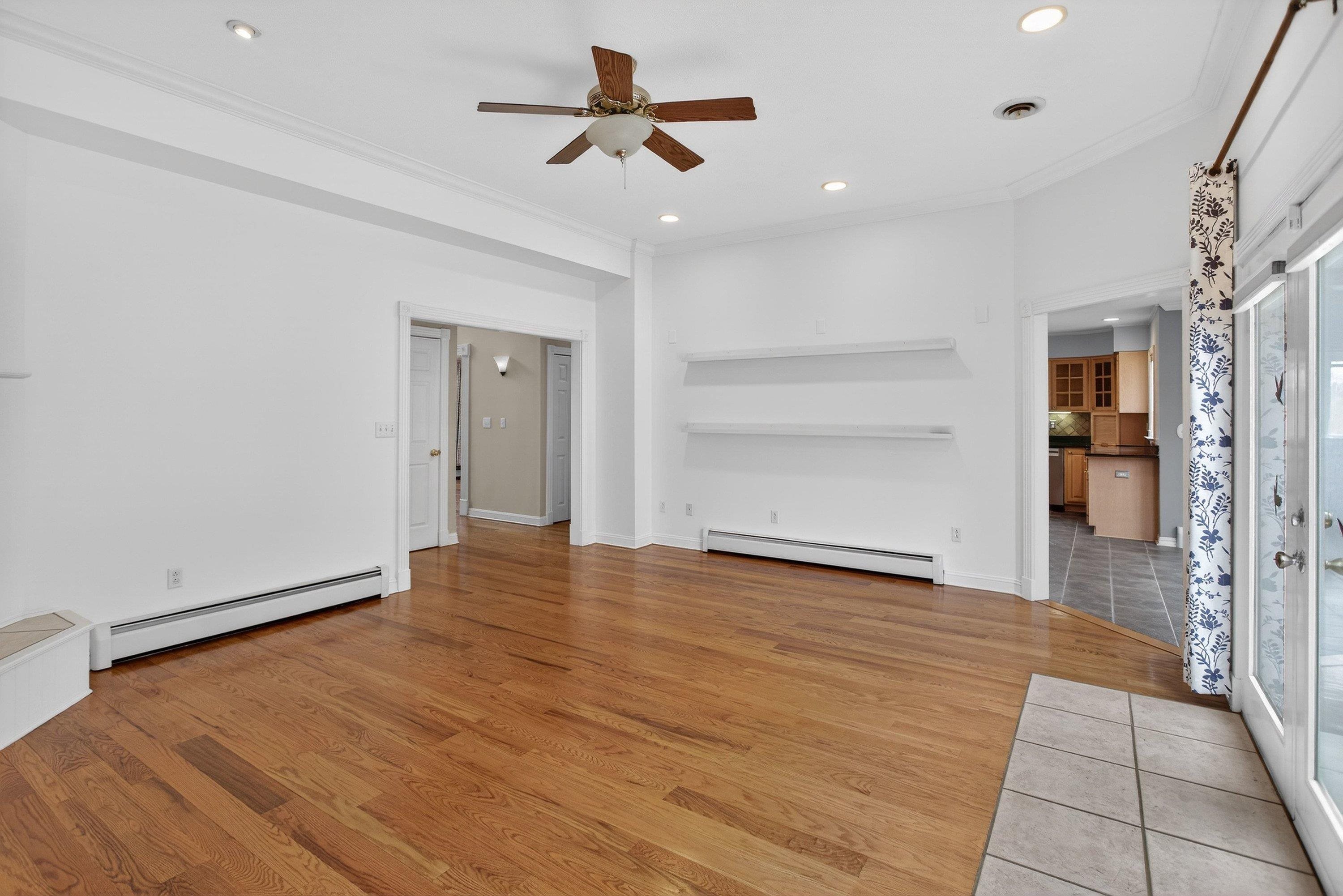 The living room offers a vaulted ceiling and hardwood treads throughout.  This space also features a gas fireplace, ceiling fan, and a large space with a lot of natural light throughout.