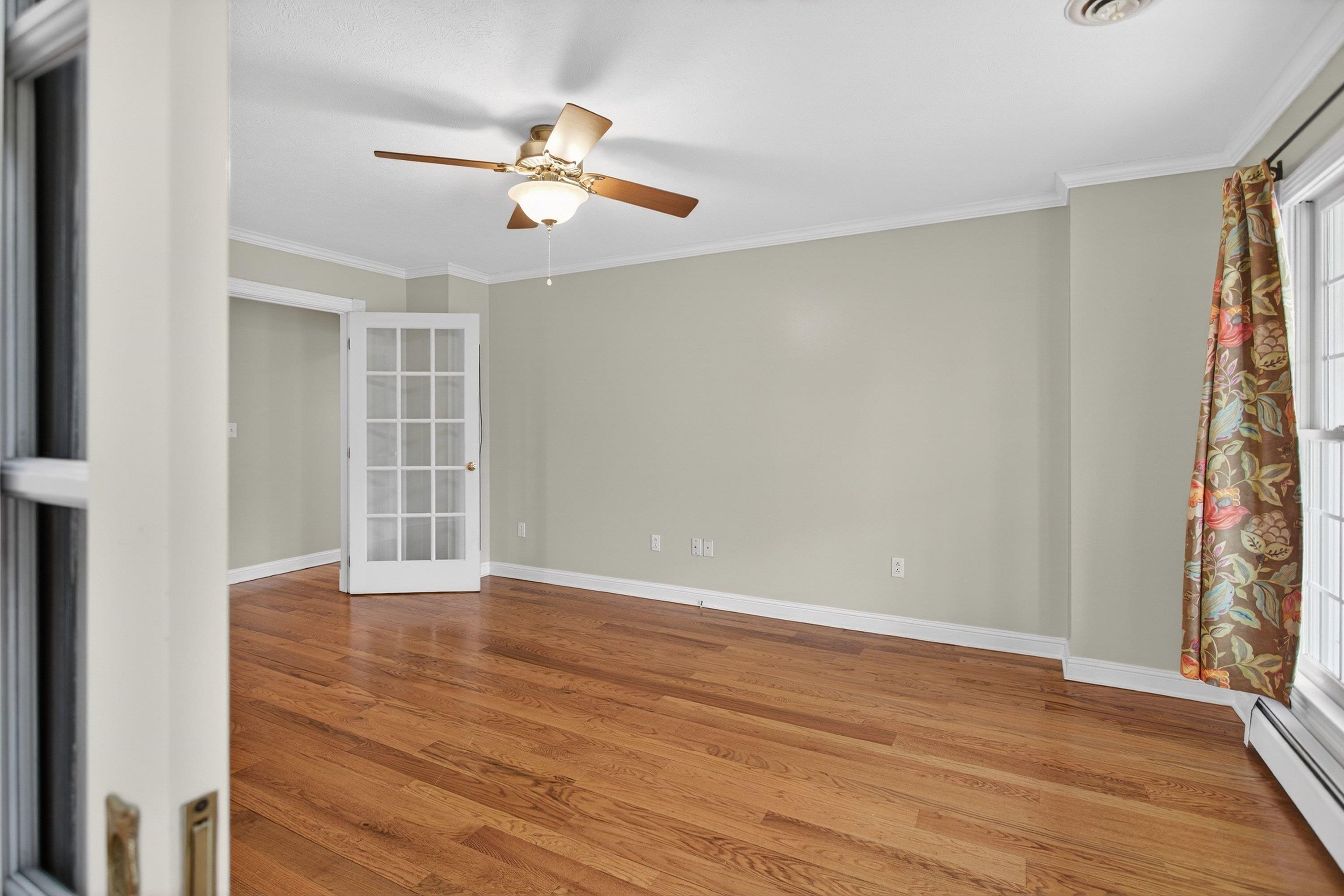 The office/family room is located off the front entrance of the home and features hardwood flooring throughout, large windows, a ceiling fan, and much more!