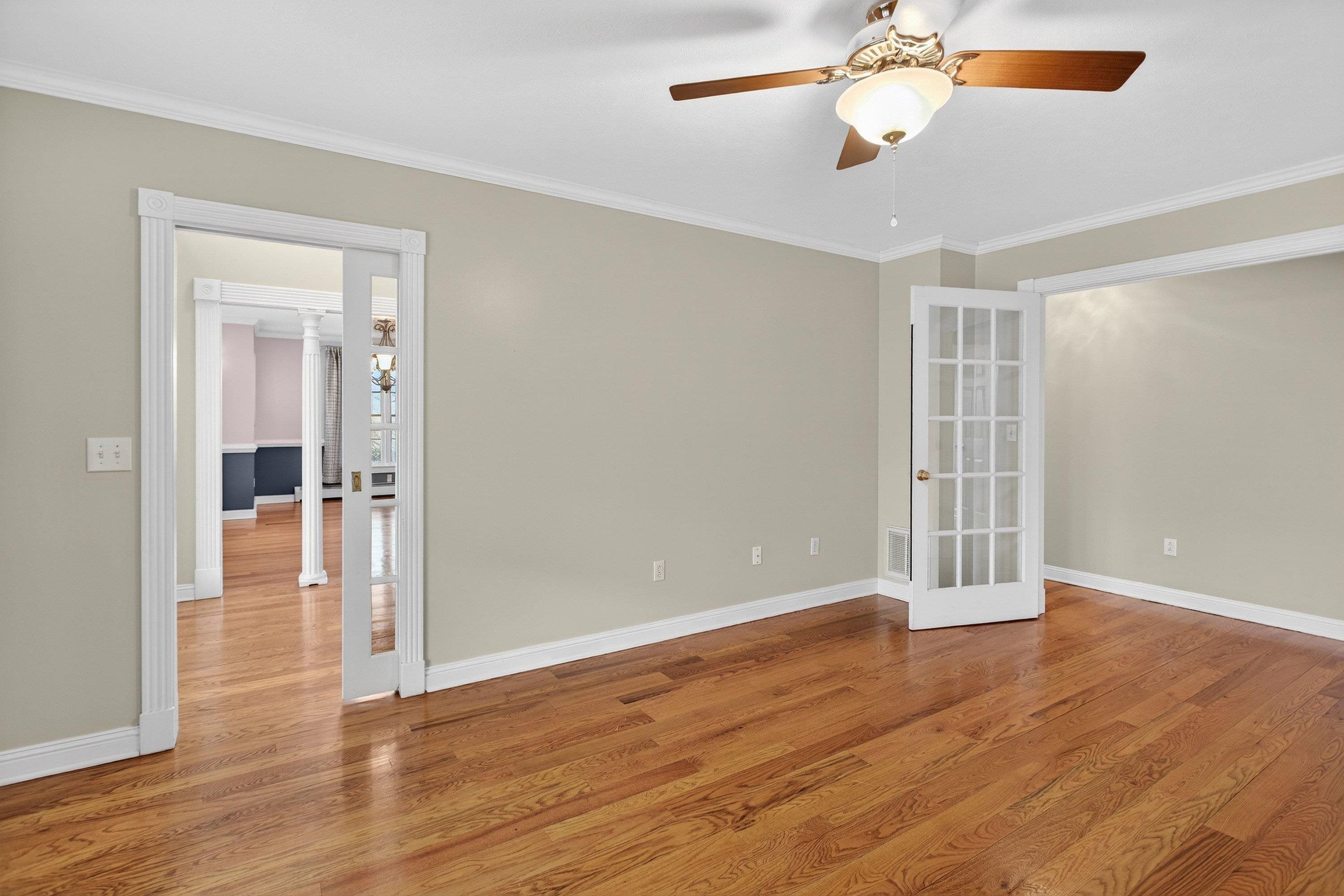 The office/family room is located off the front entrance of the home and features hardwood flooring throughout, large windows, a ceiling fan, and much more!
