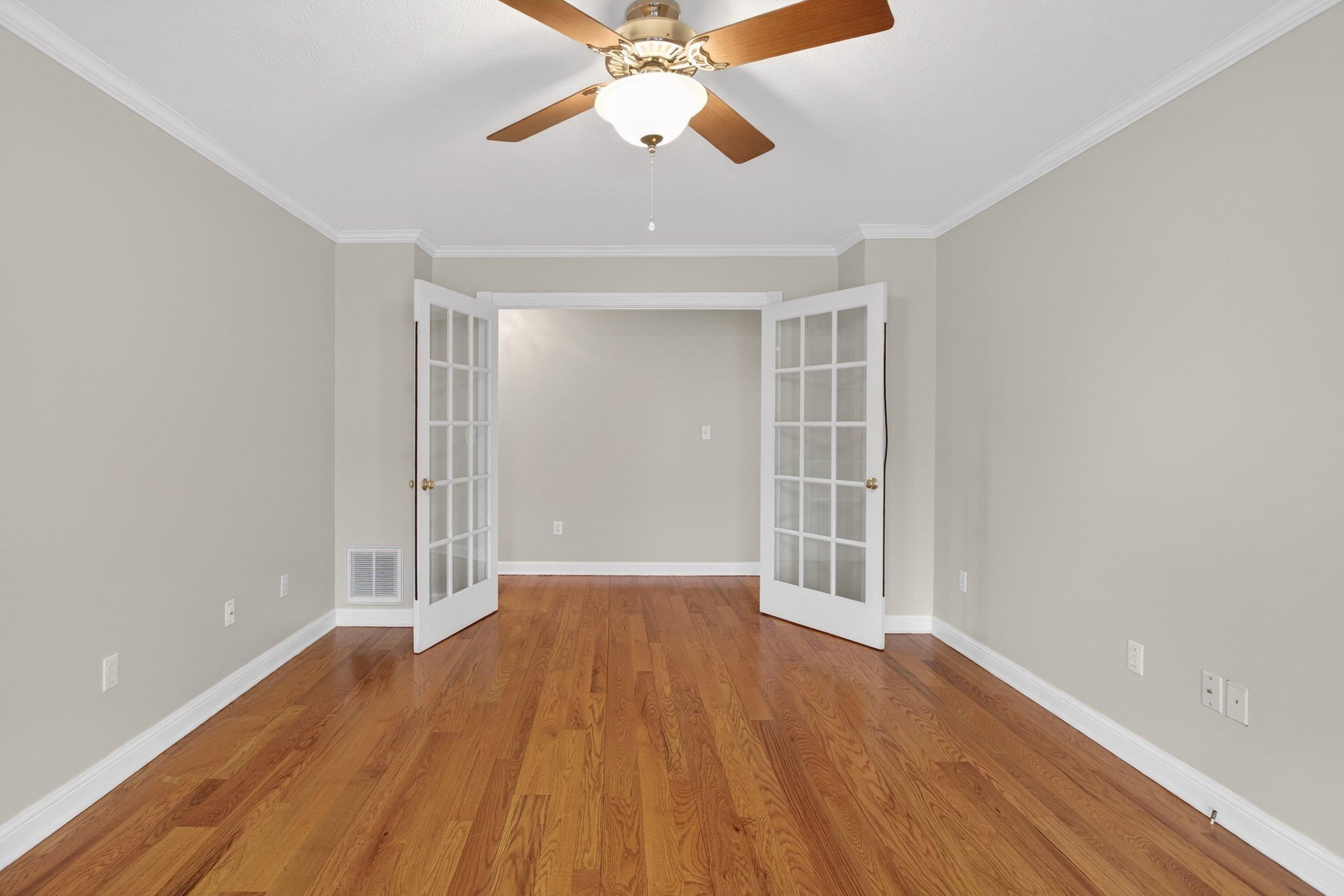 The office/family room is located off the front entrance of the home and features hardwood flooring throughout, large windows, a ceiling fan, and much more!