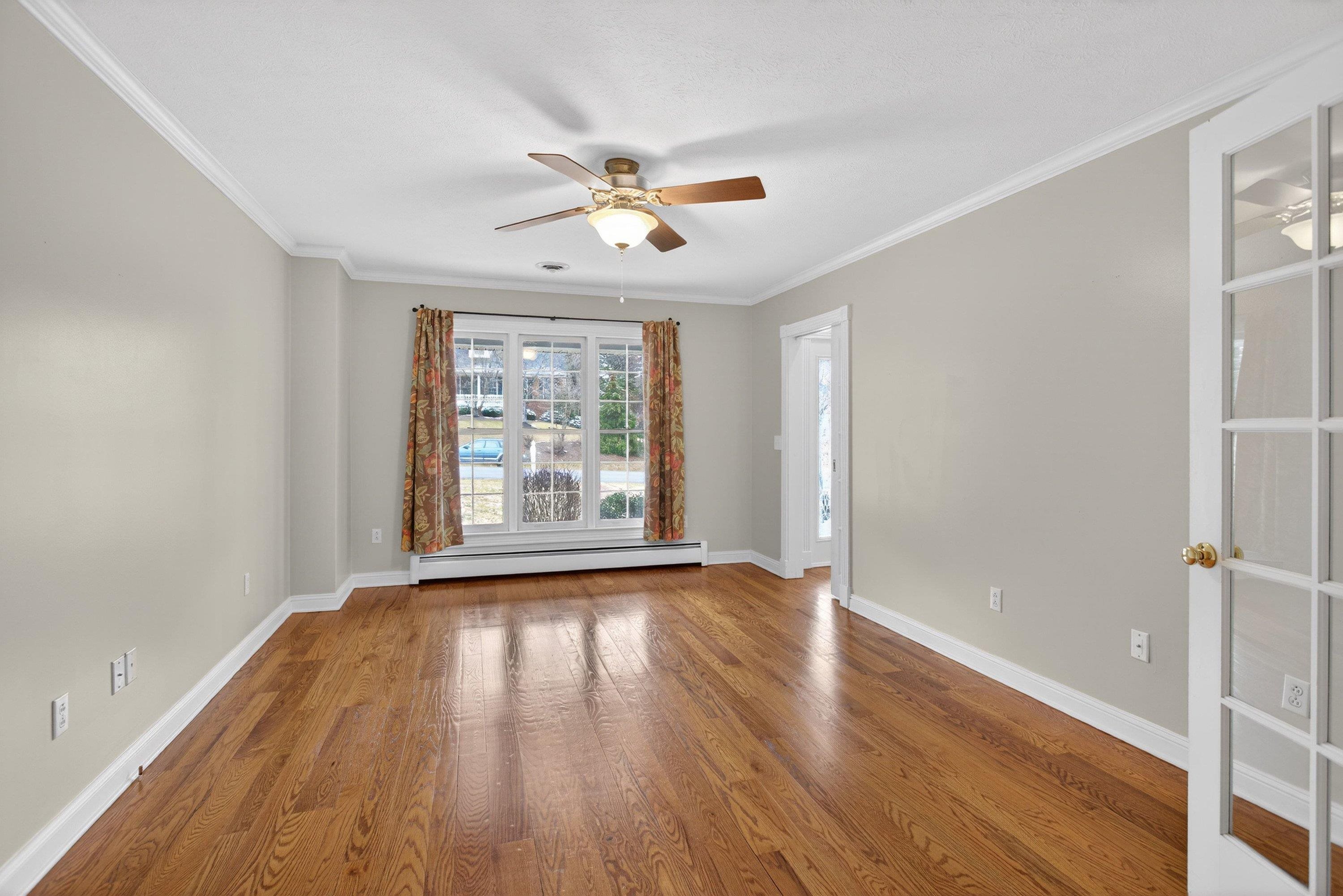 The office/family room is located off the front entrance of the home and features hardwood flooring throughout, large windows, a ceiling fan, and much more!