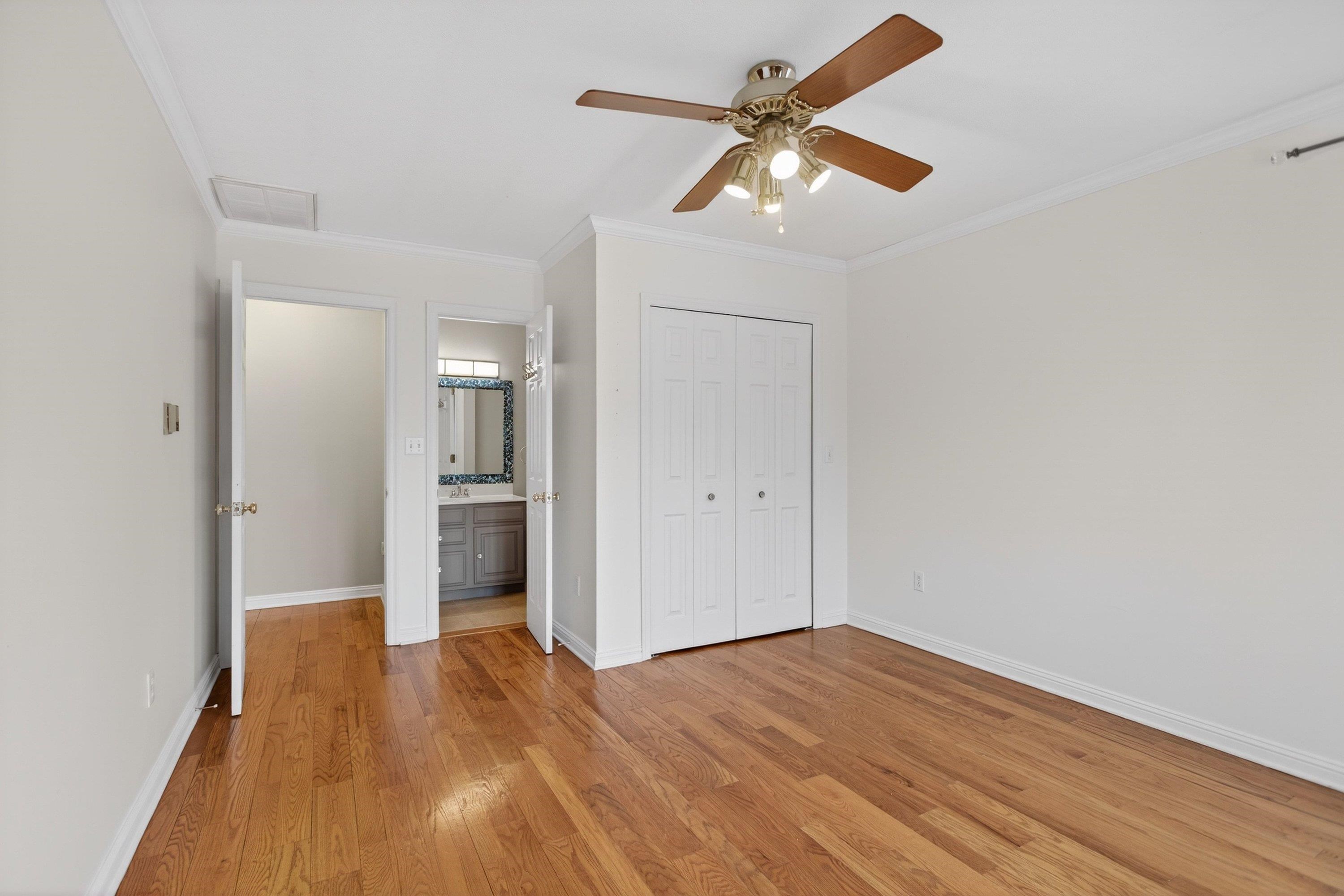 This second bedroom offers hardwood flooring throughout, ceiling fan, large windows, and a full attached bathroom.
