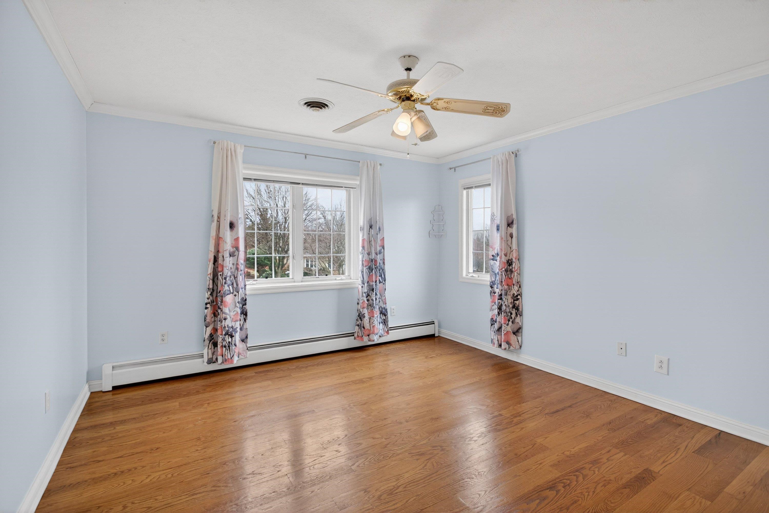 This third bedroom offers hardwood flooring throughout, large windows, a ceiling fan, and a jack and jill style bathroom.  This bedroom also features large closets for storage.