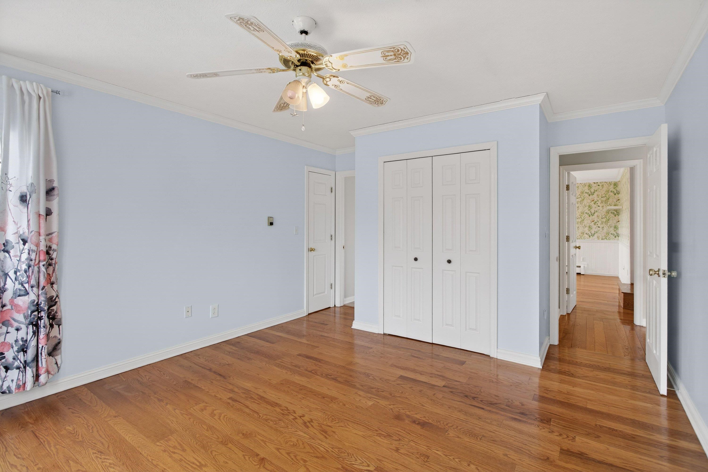 This third bedroom offers hardwood flooring throughout, large windows, a ceiling fan, and a jack and jill style bathroom.  This bedroom also features large closets for storage.