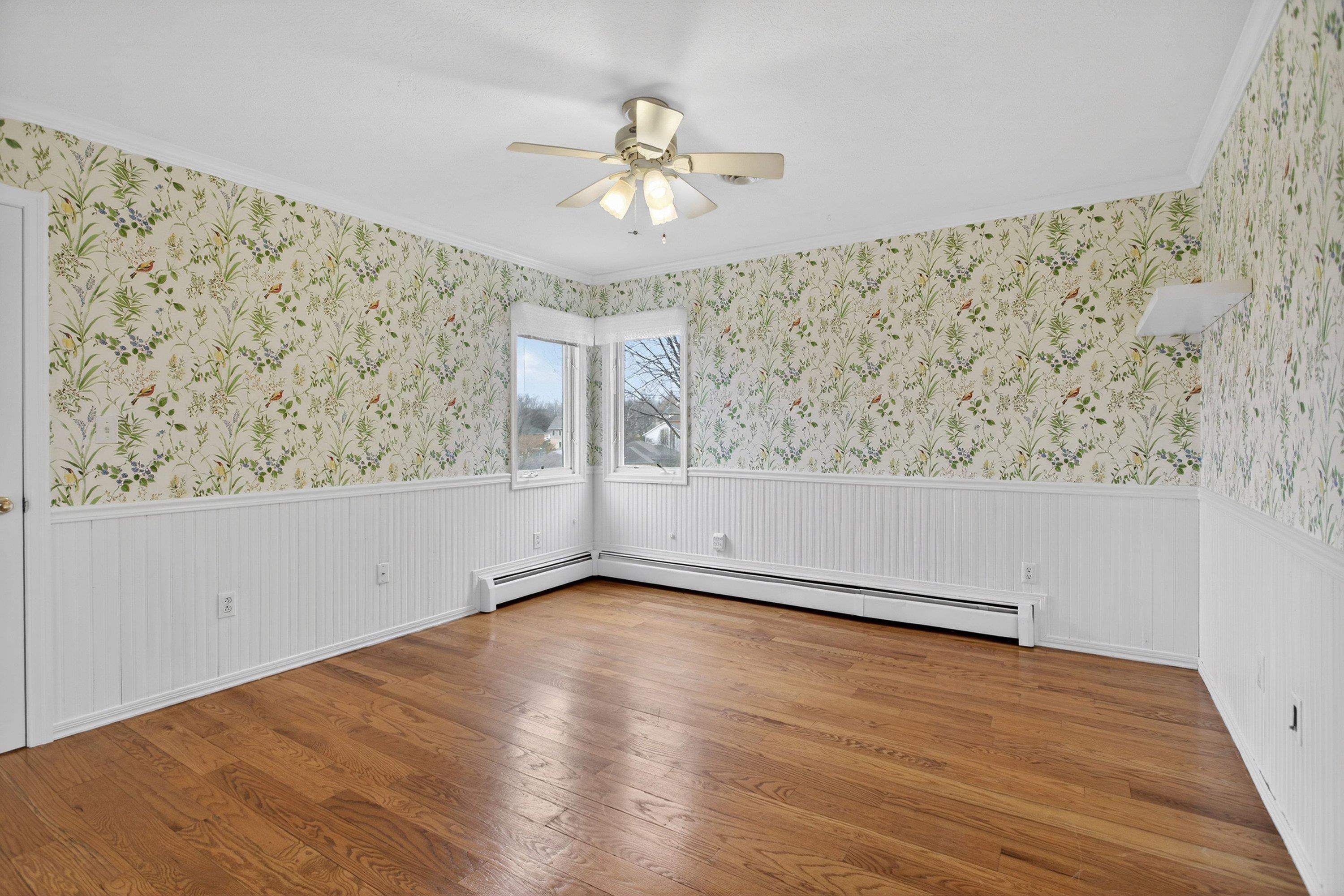 This fourth bedroom offers hardwood flooring throughout, a ceiling fan, large windows, and a large closet.  This room also has a spacious bonus room area.