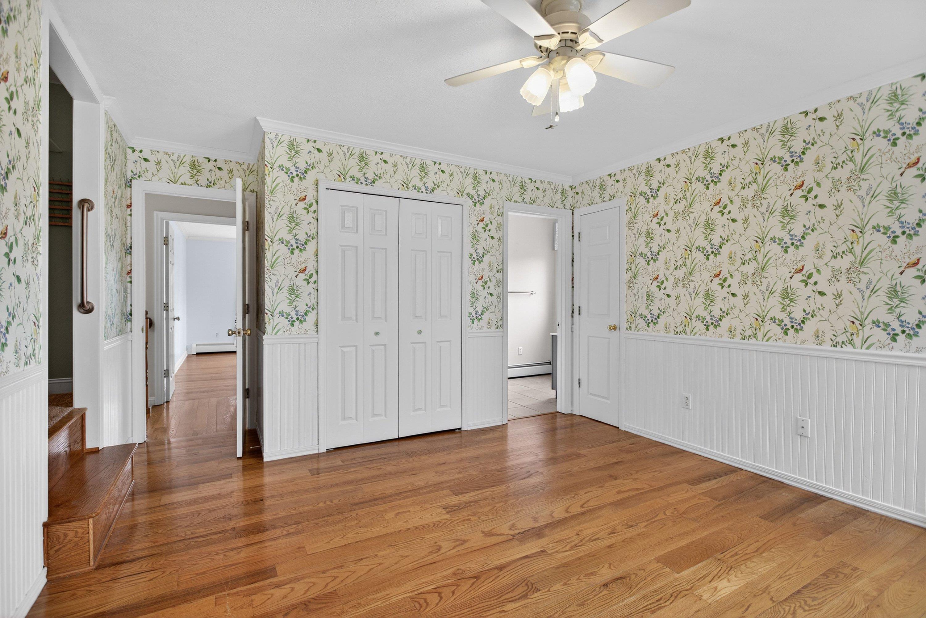 This fourth bedroom offers hardwood flooring throughout, a ceiling fan, large windows, and a large closet.  This room also has a spacious bonus room area.