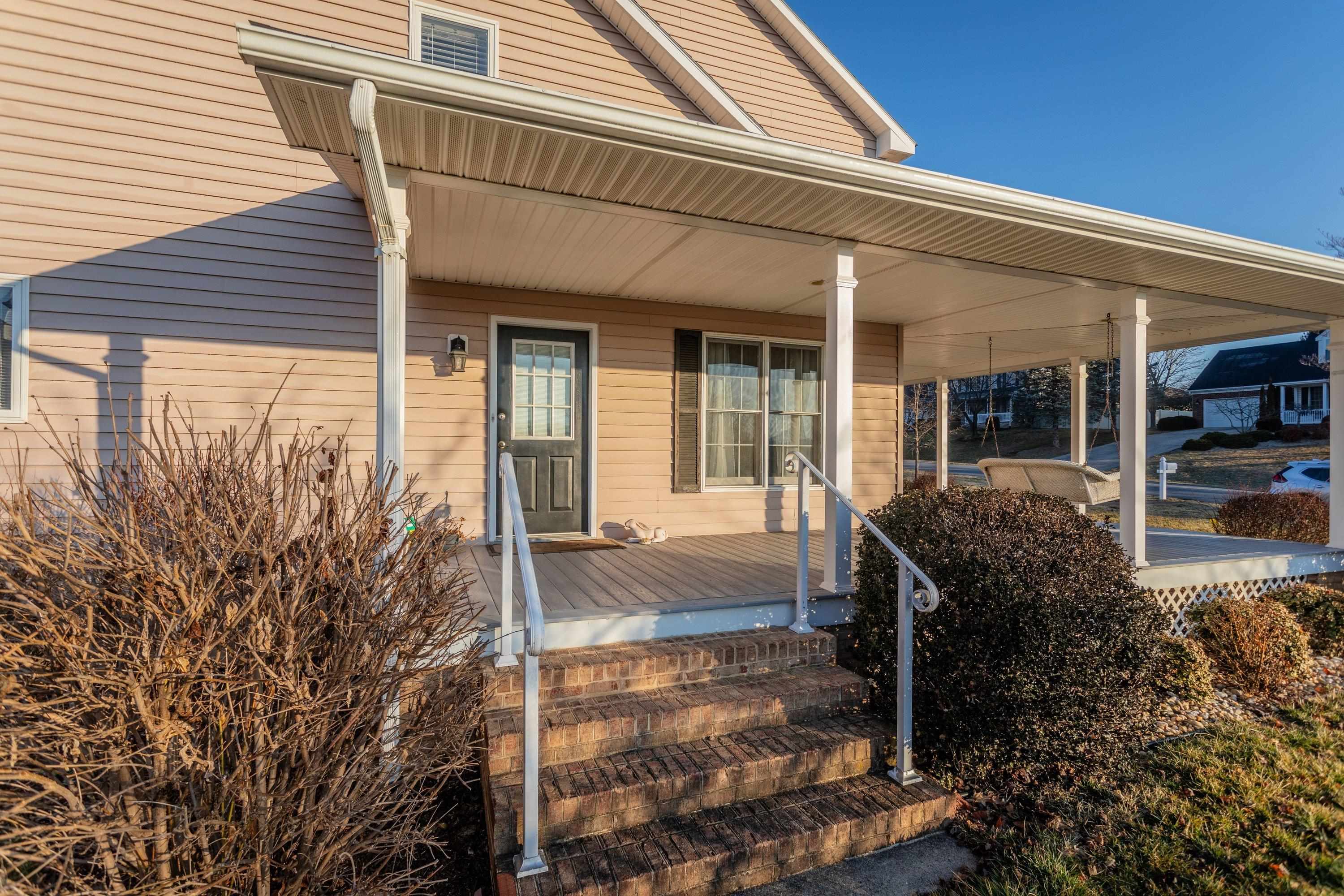 The front porch is very large and wraps around the front and sides of the home.  This porch offers composite deck flooring boards, and offers plenty of space for sitting and gathering with family and friends.