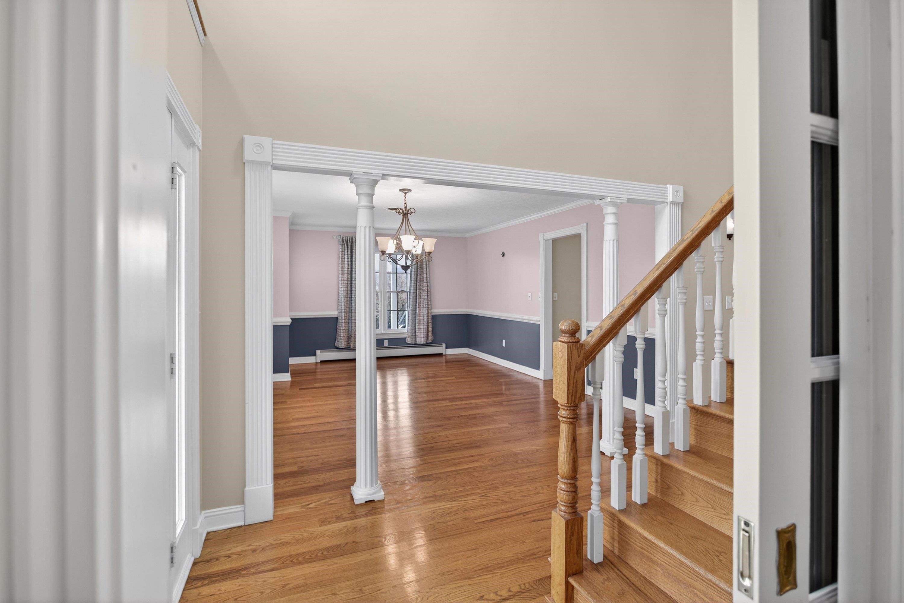 The large foyer space greets you as you enter the home, and features hardwood flooring, decorative windows, and hardwood treads leading to the upper level of the home.