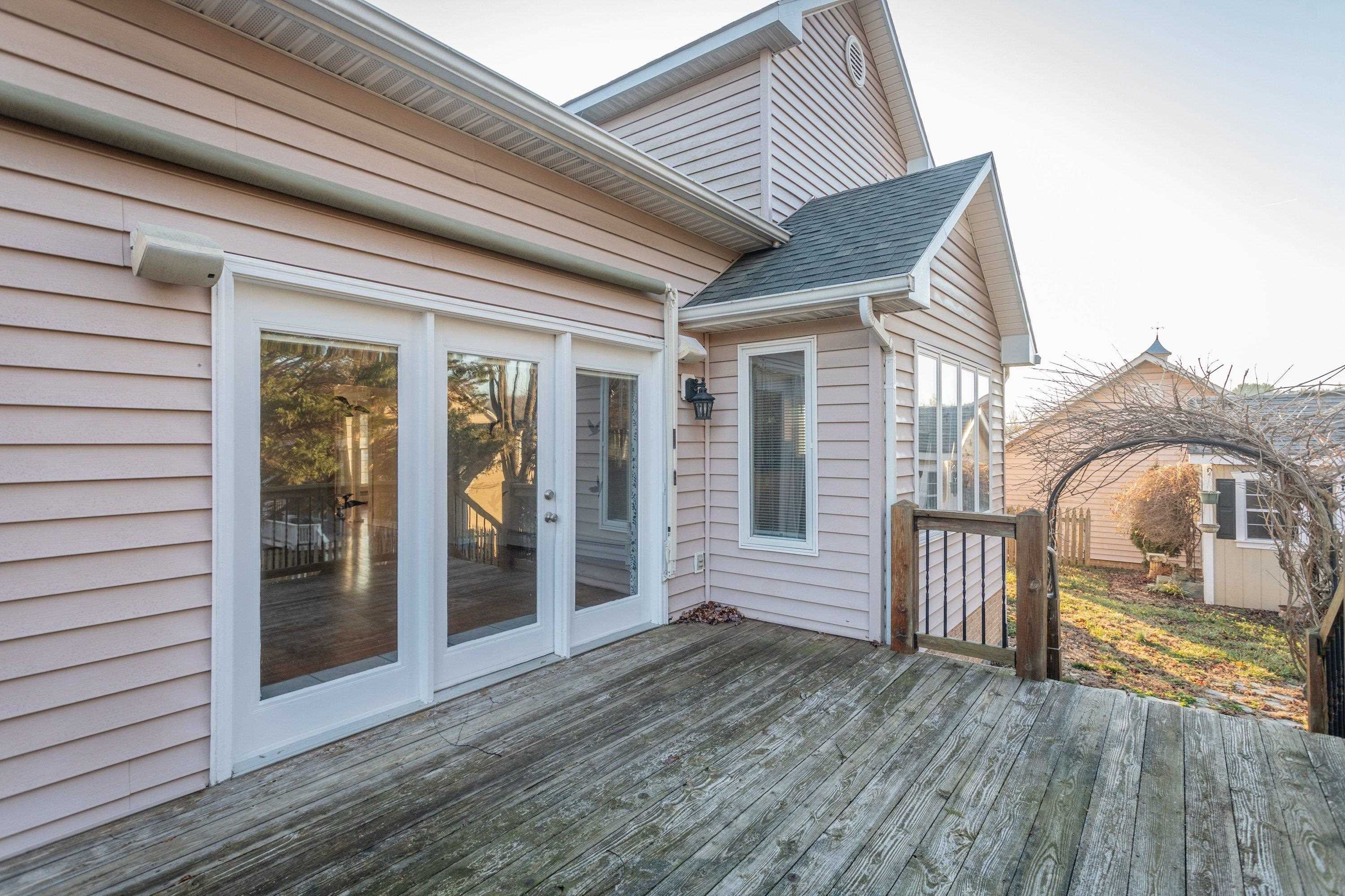 The rear deck offers a large space for gathering with family & friends.  This space is easily accessible from the indoor kitchen/dining area in the home.