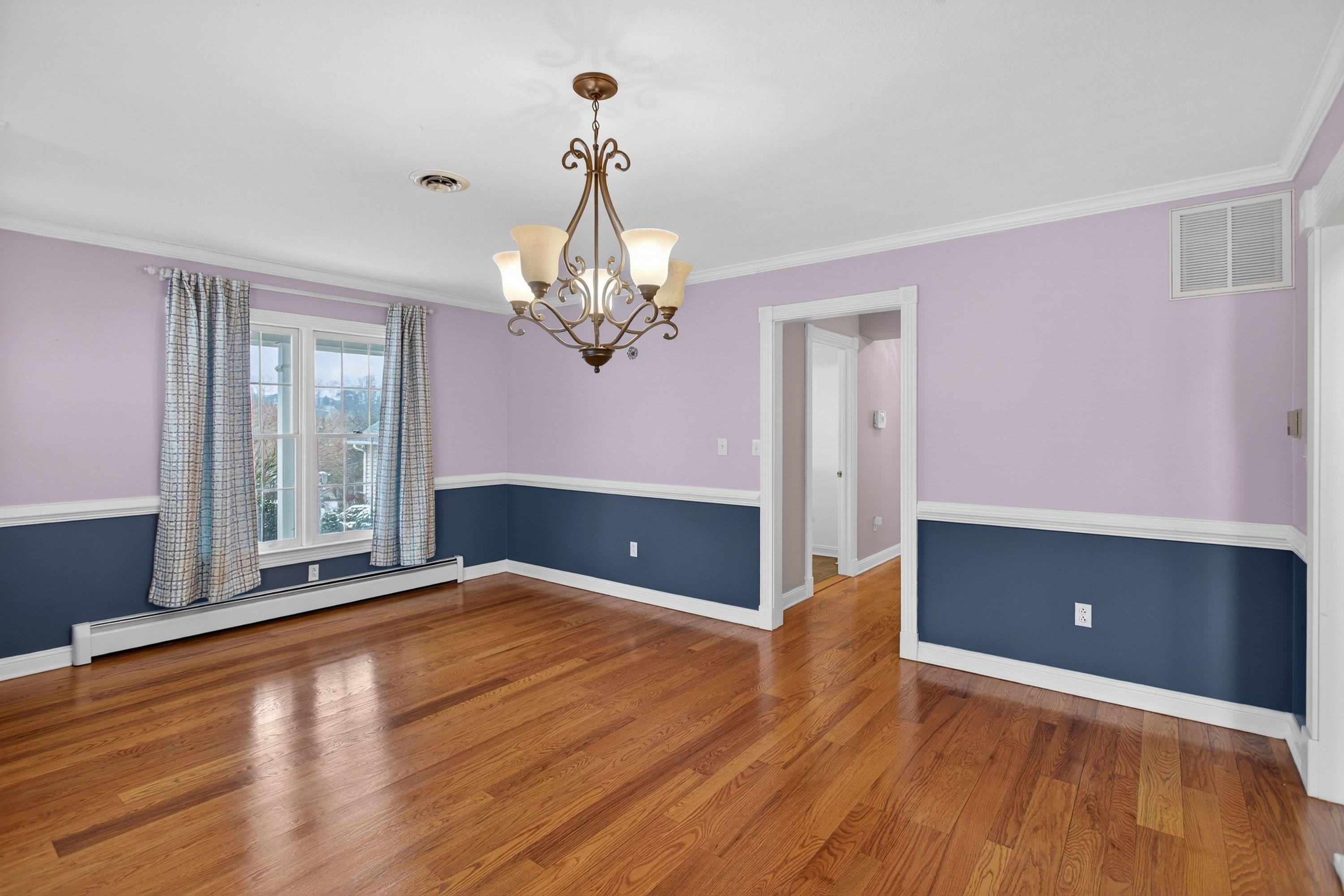 The formal dining room is located near the front of the home.  This space features hardwood floors, chandelier, chair railing, and more!  This space offers plenty of space for a table & chairs set.