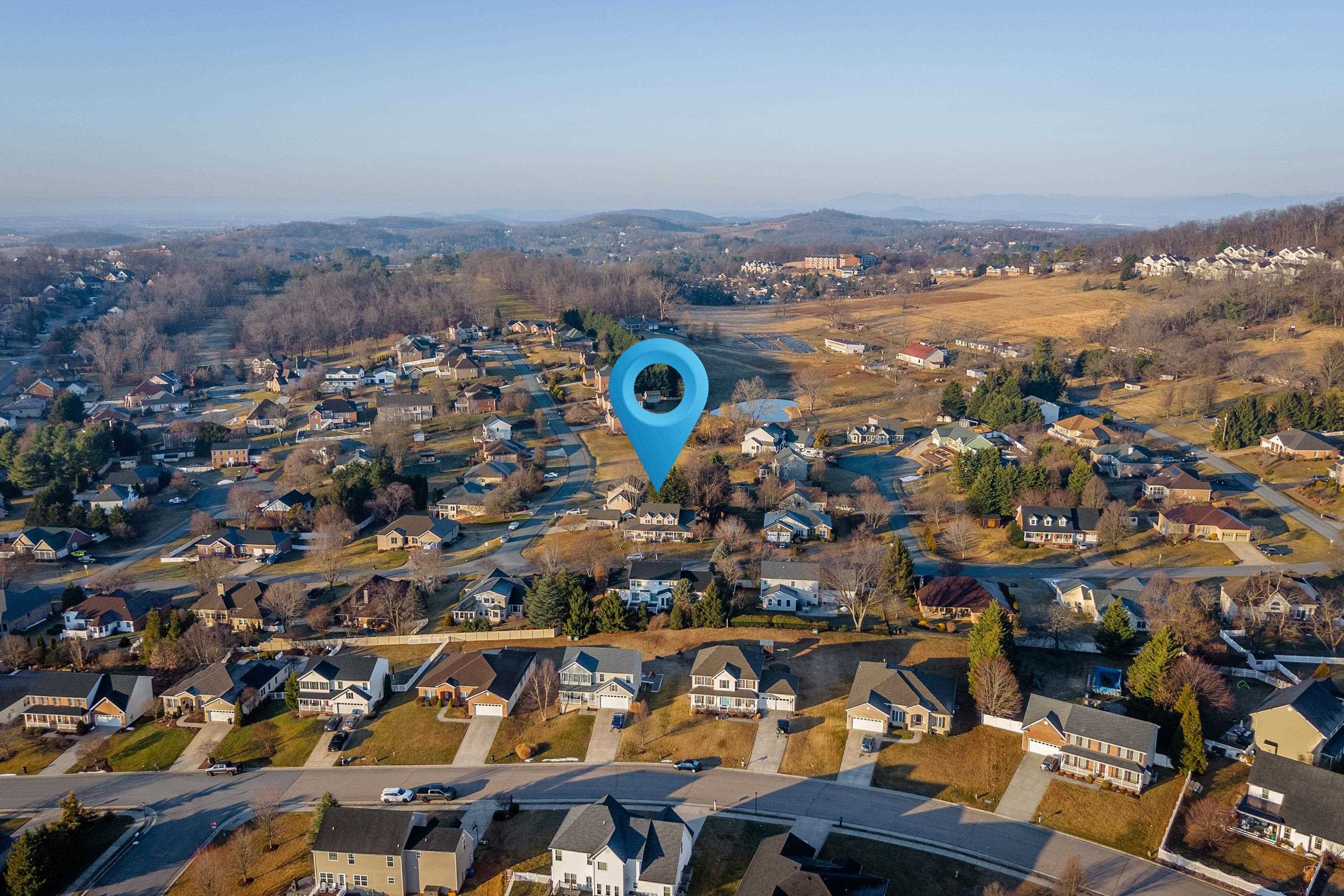 The aerial view highlights the large, level lot of the home, surrounding neighborhood of Battlefield Estates, nearby mountain views, and much more!