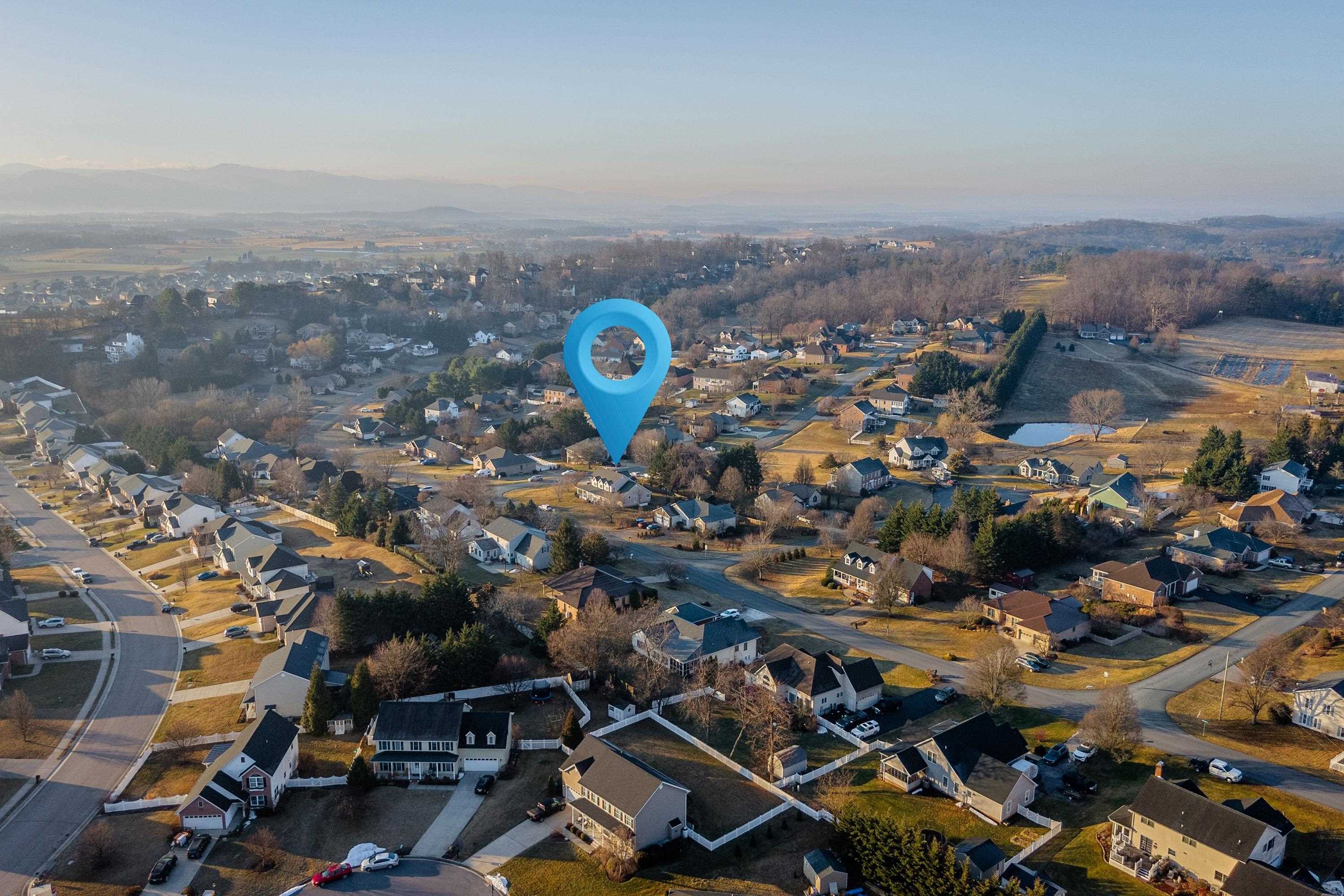 The aerial view highlights the large, level lot of the home, surrounding neighborhood of Battlefield Estates, nearby mountain views, and much more!