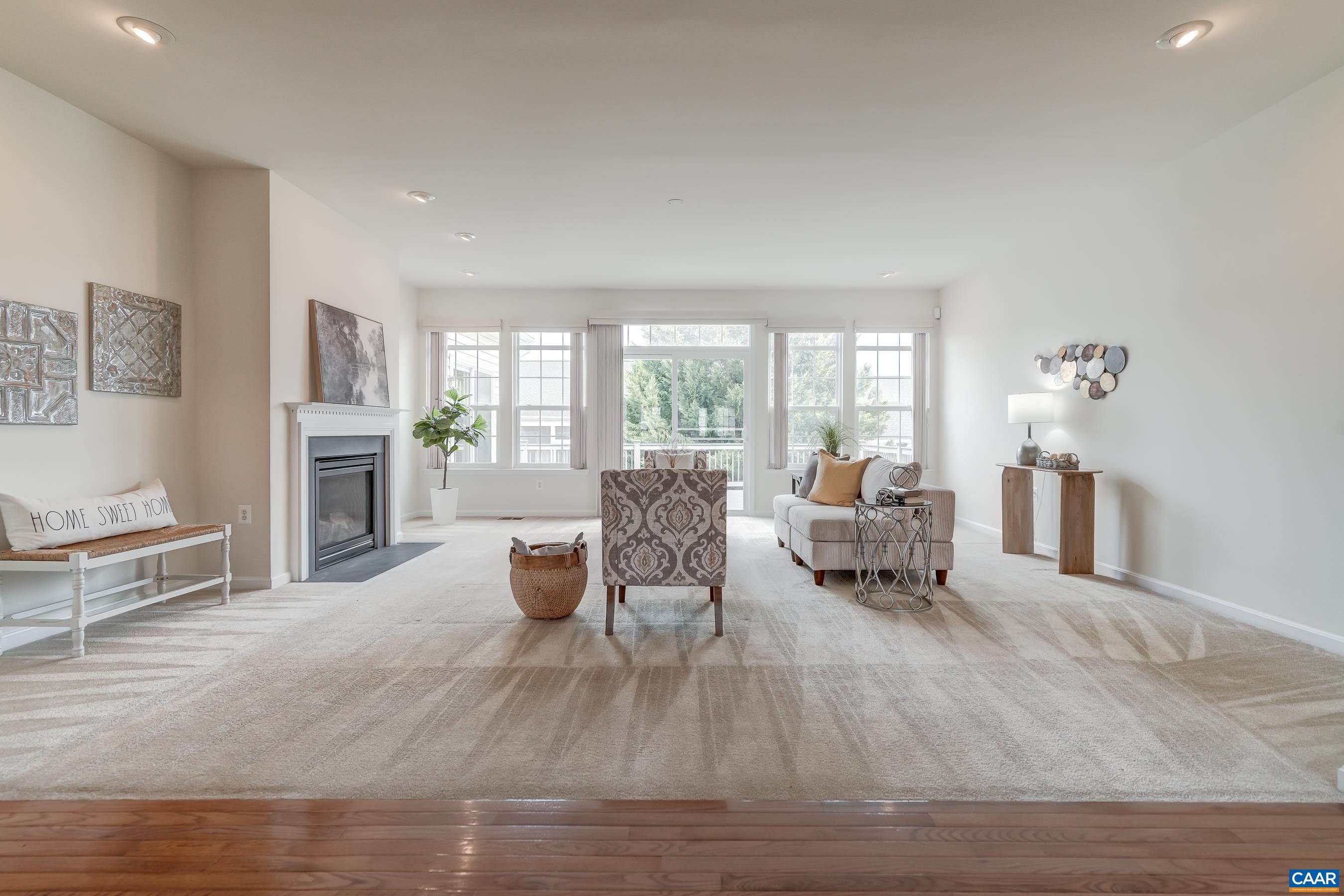 Large light-filled living room features a gas fireplace.