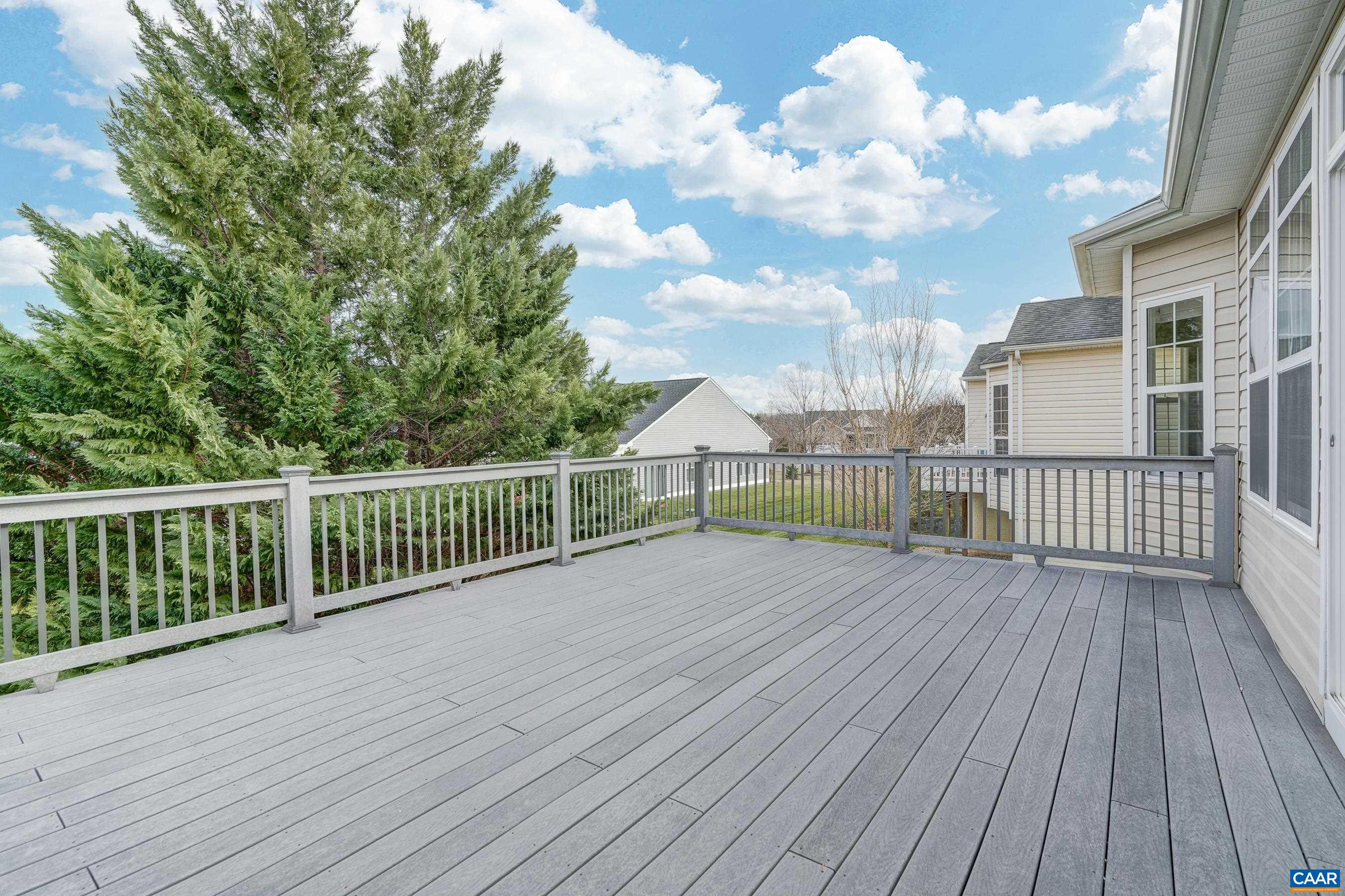Spacious composite deck with privacy screening plantings and plumbed gas-line for easy grilling.