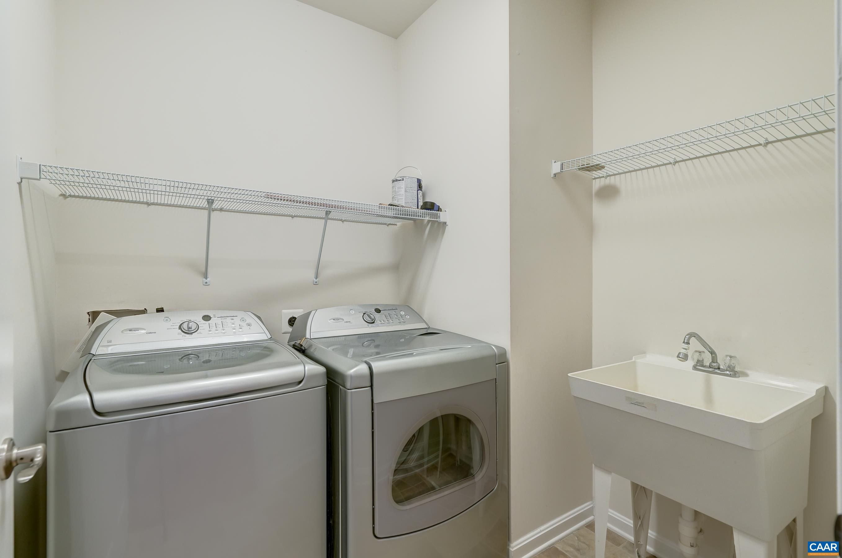 Laundry room with washer/dryer and utility sink.