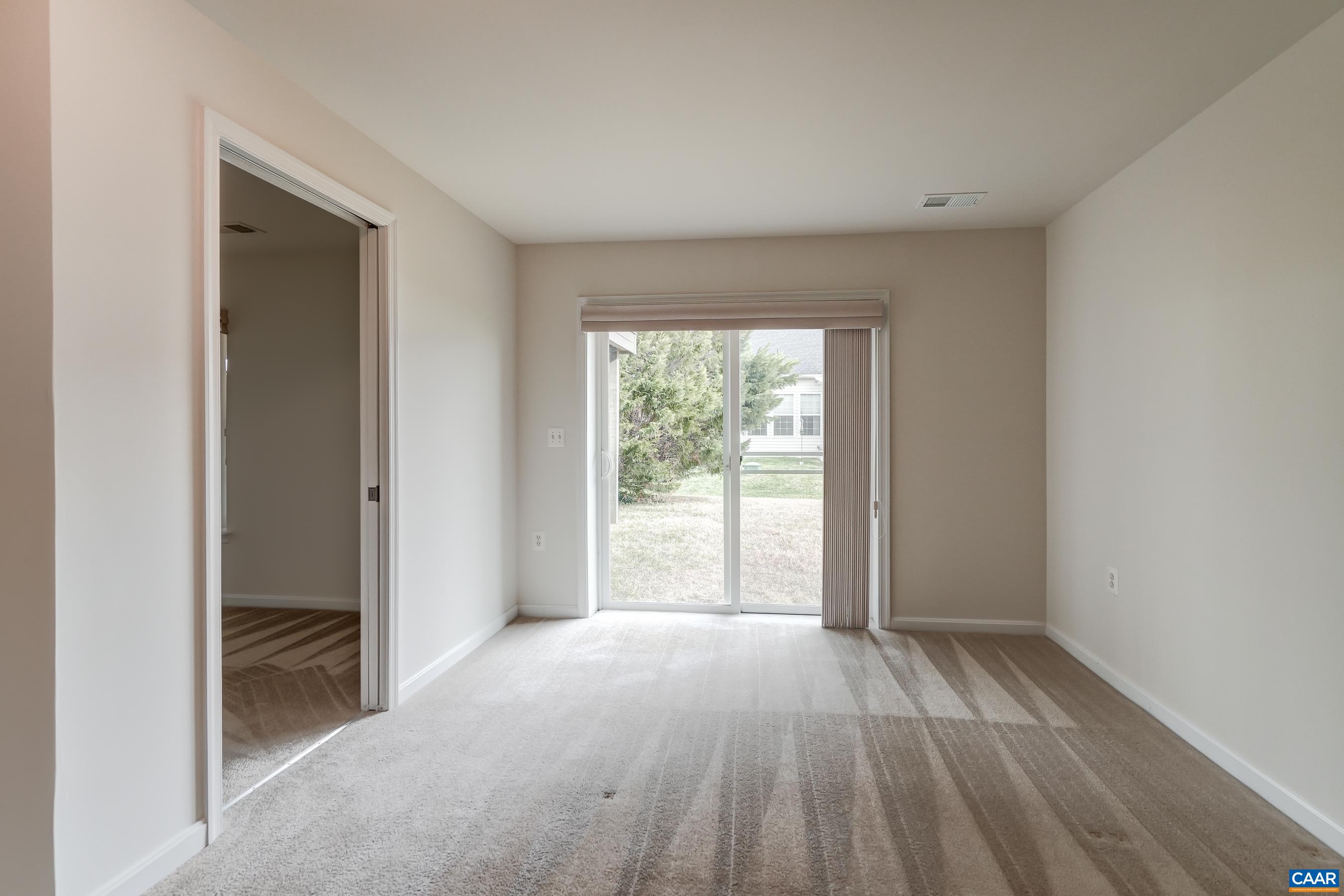 Sliding doors lead to rear yard.