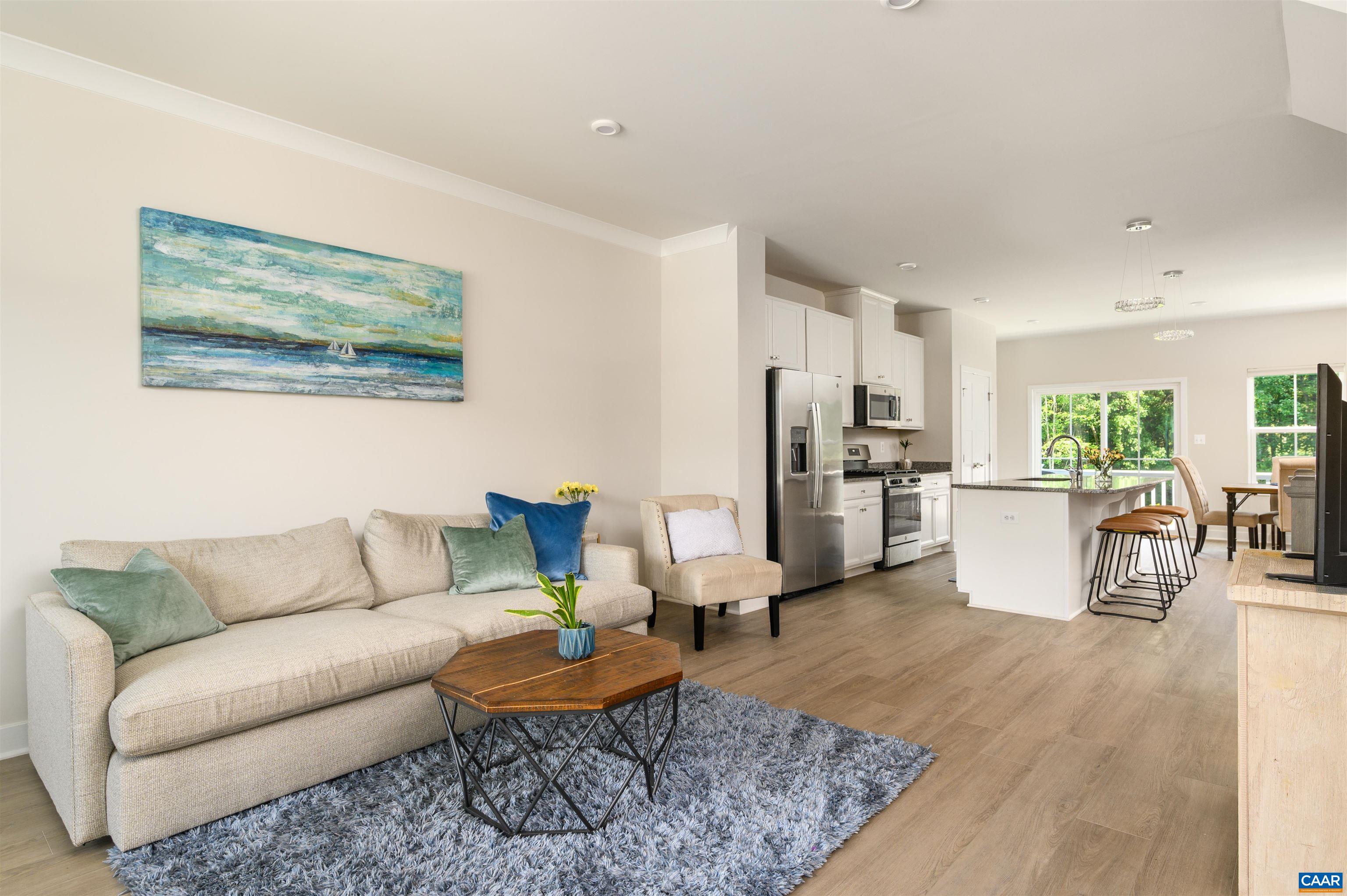 Open-concept living space with abundant natural light, durable flooring, and seamless flow to the kitchen and dining areas.