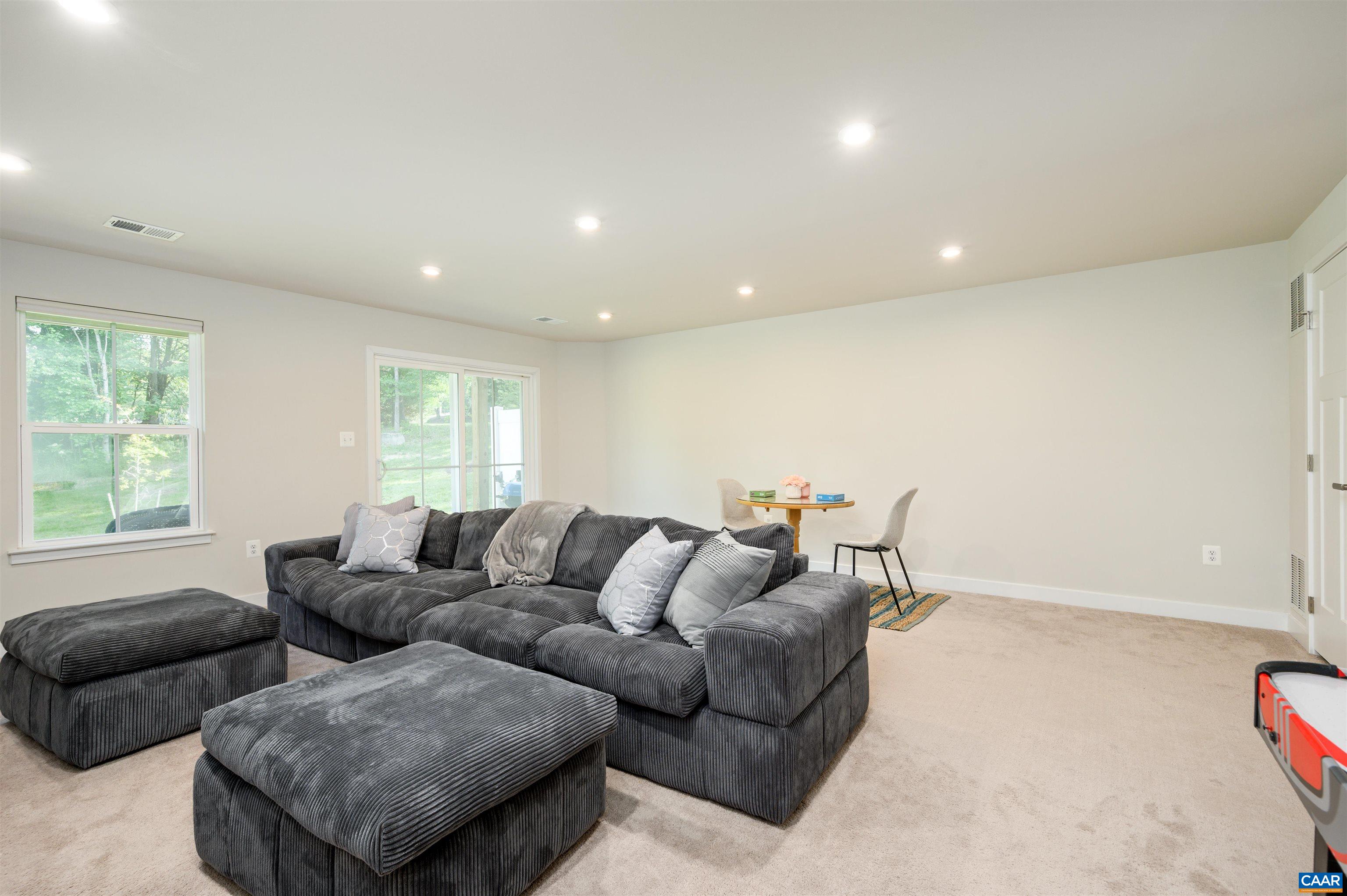 Expansive lower-level recreation room with plush carpet, recessed lighting, and direct access to the backyard. Ideal for movie nights, a home gym, or game-day gatherings.
