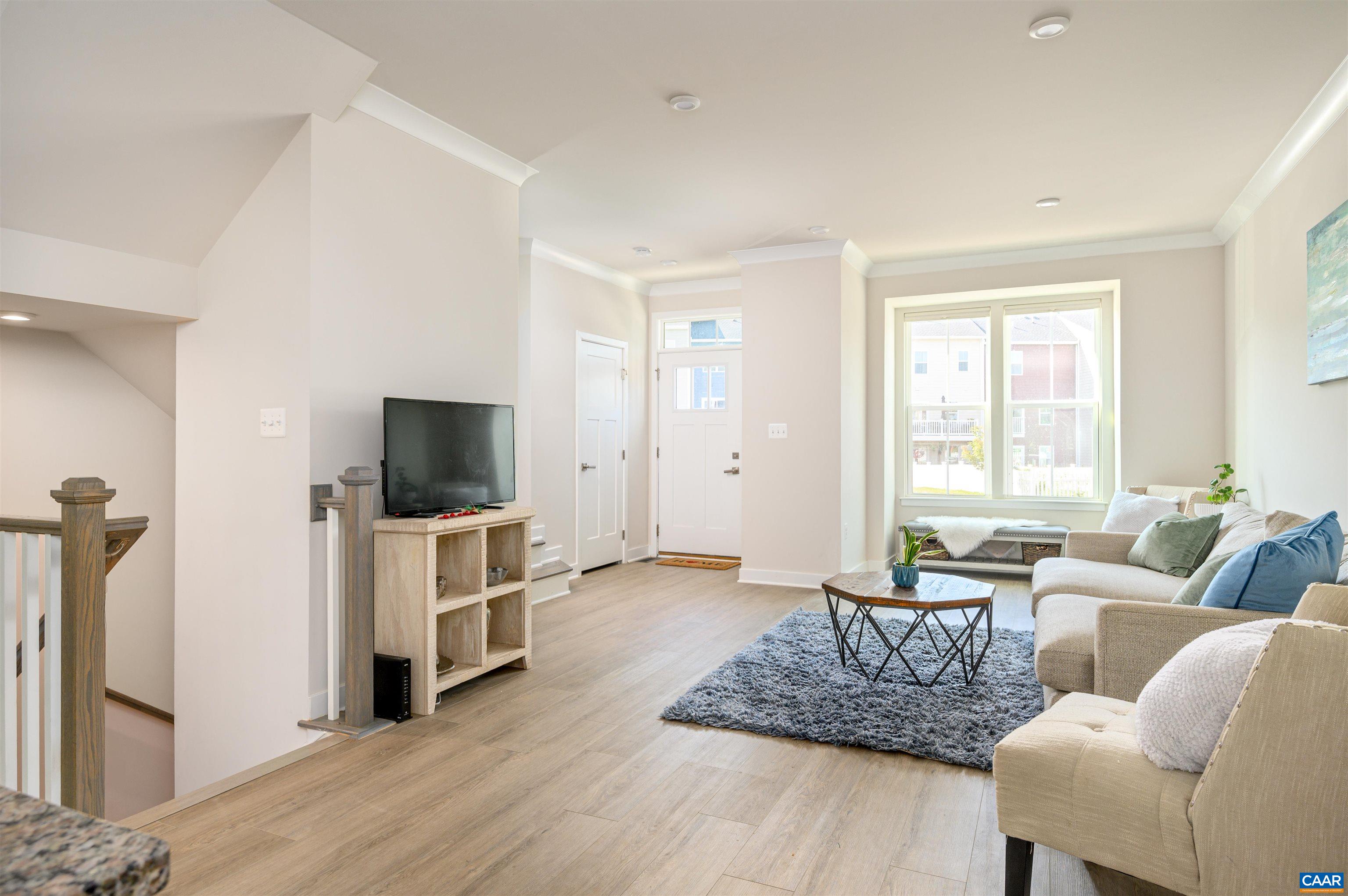 Open-concept living space with abundant natural light, durable flooring, and seamless flow to the kitchen and dining areas.