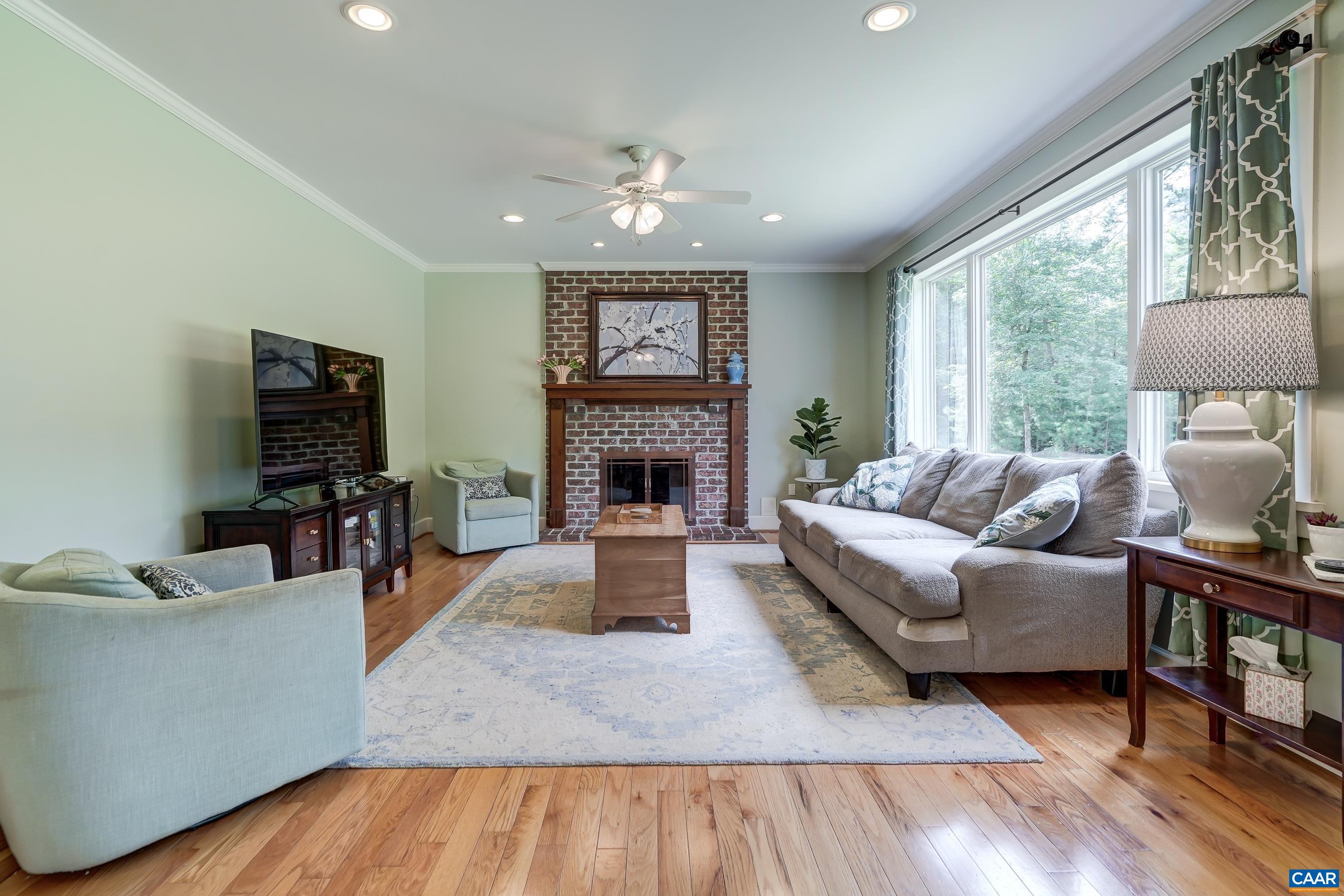 Great room features brick wood burning fireplace and large picture window.
