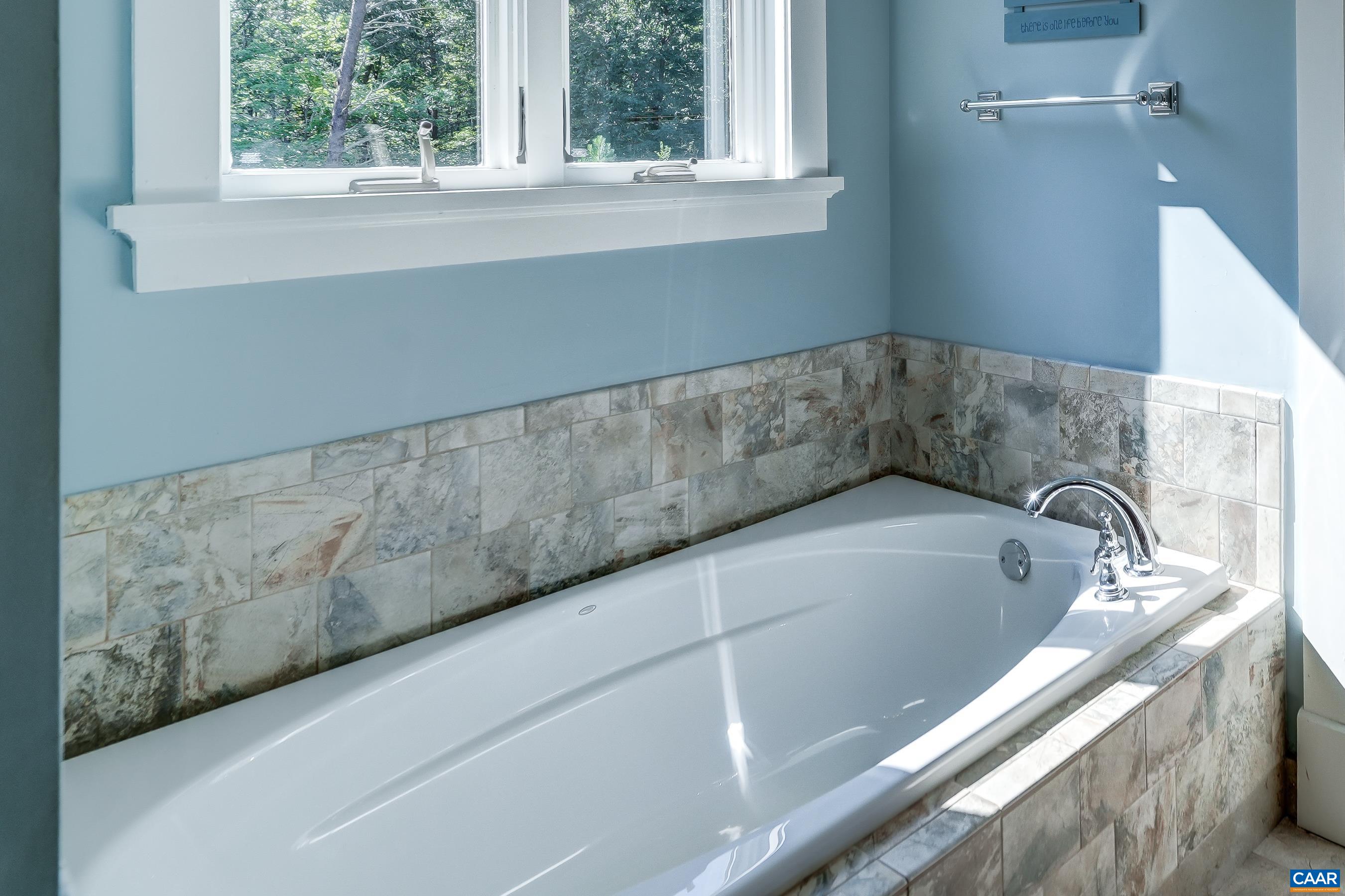 Large soaking tub in primary bathroom.