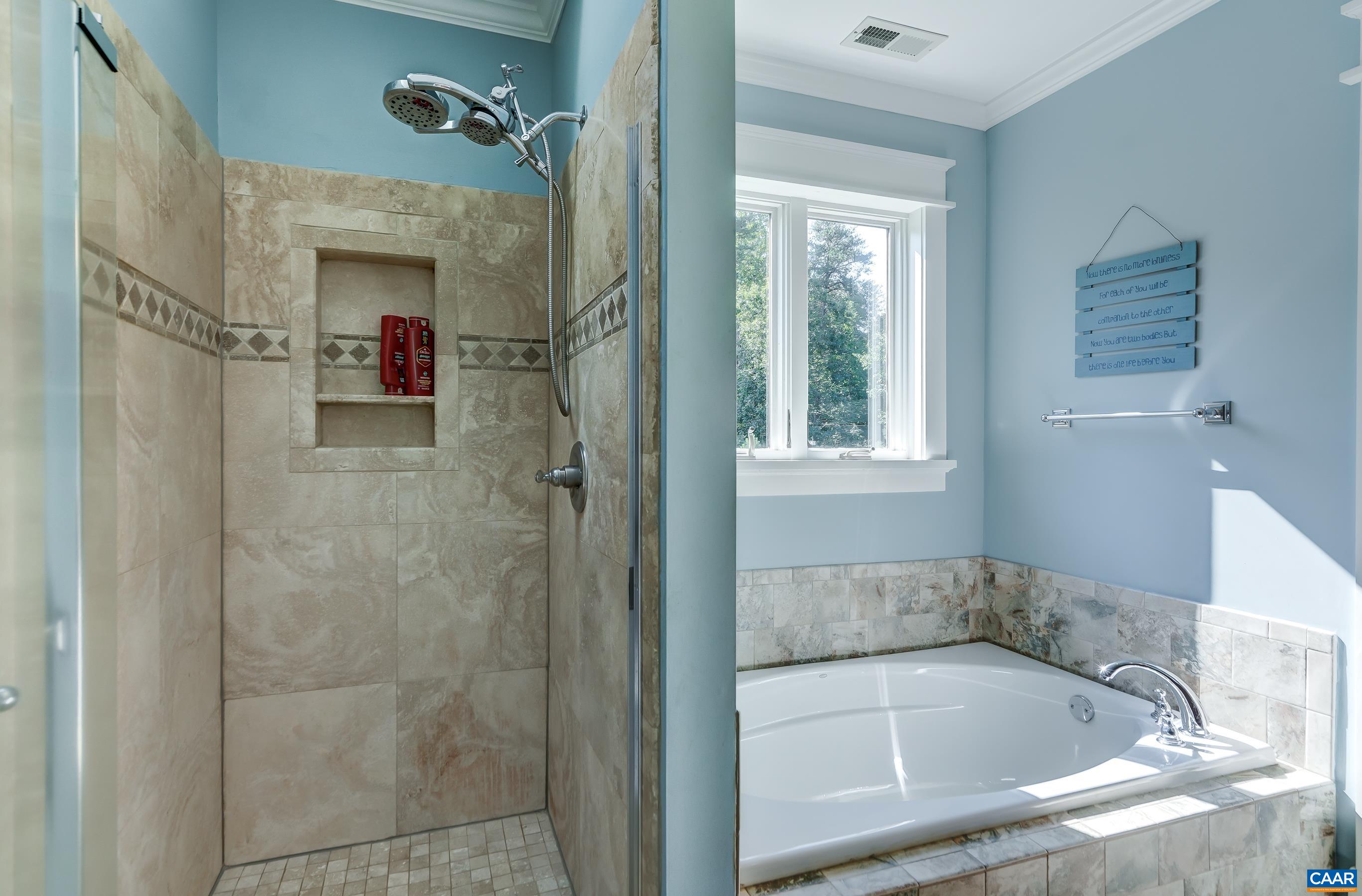 Separate tiled shower in primary bathroom.
