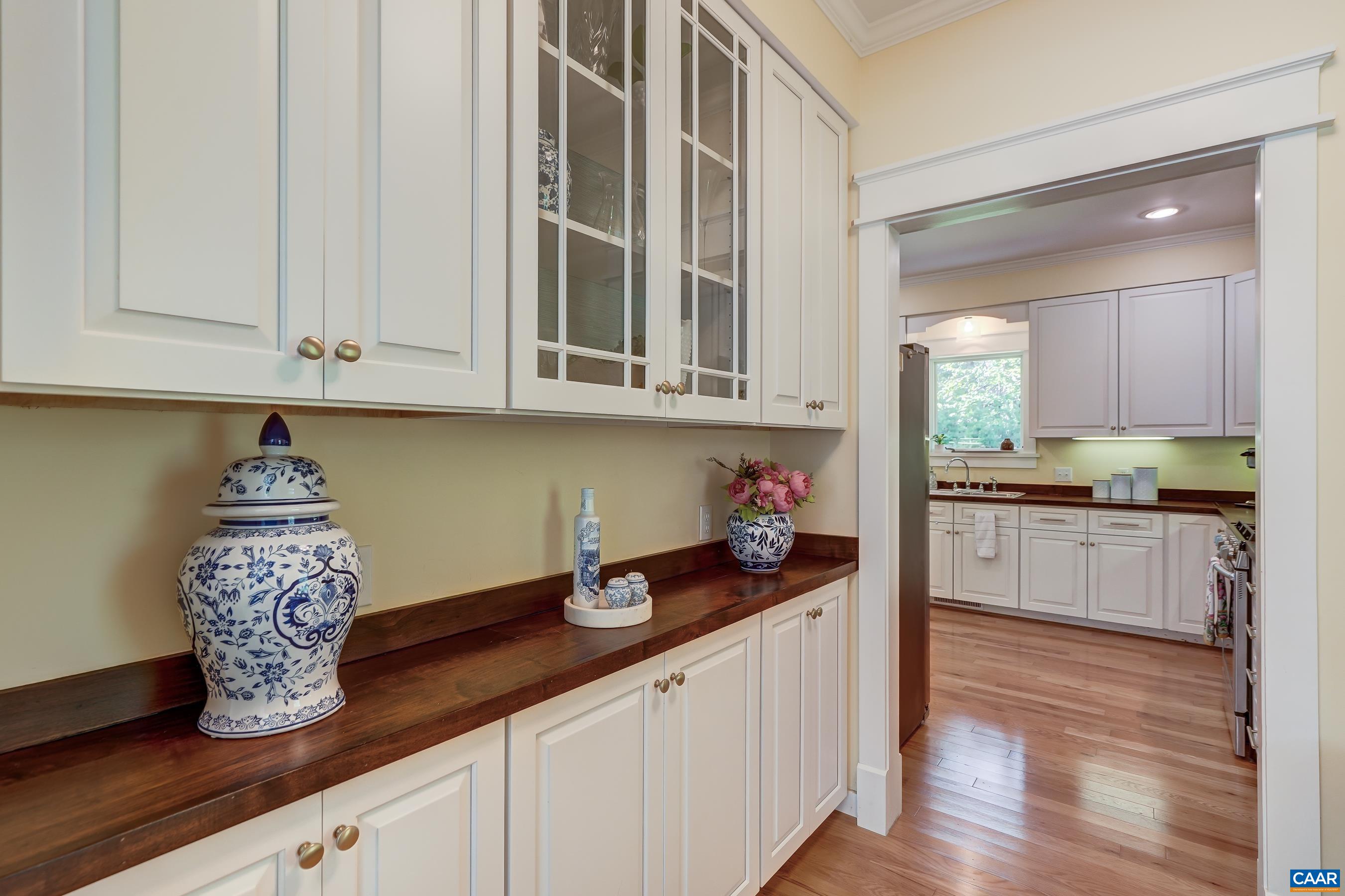 Butlers pantry with walnut counters connects the dining room and kitchen.
