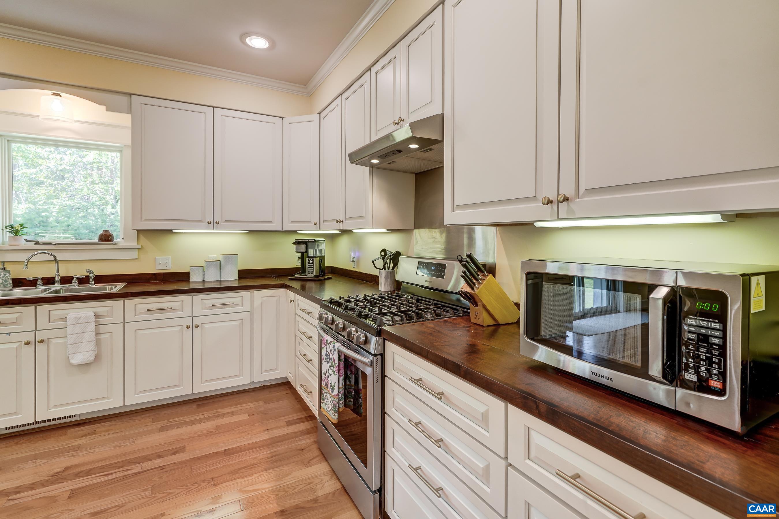 Functional kitchen with walnut counters milled from trees on the property!