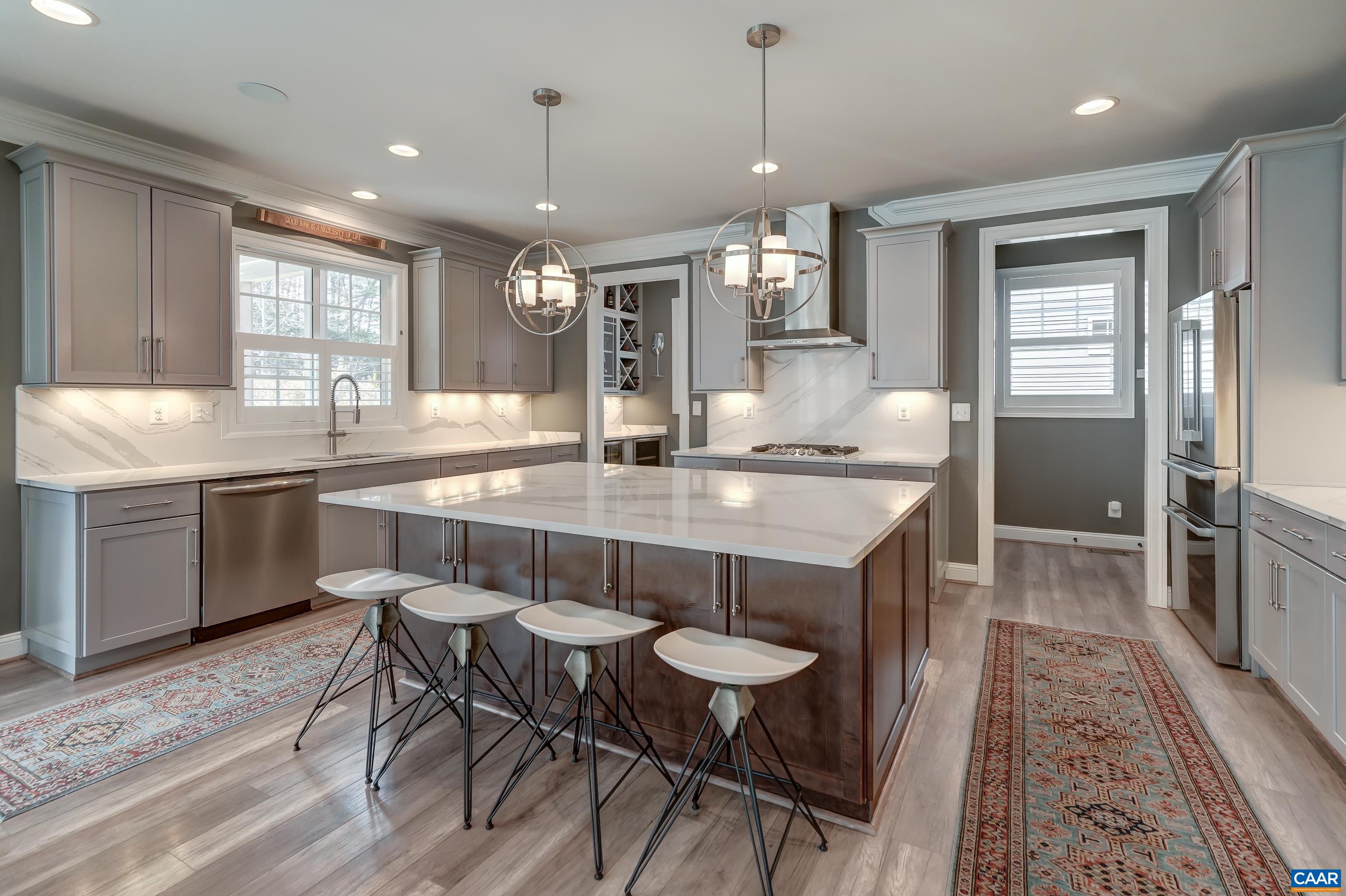Gourmet kitchen with expansive Quartz island, countertops and matching backsplash.