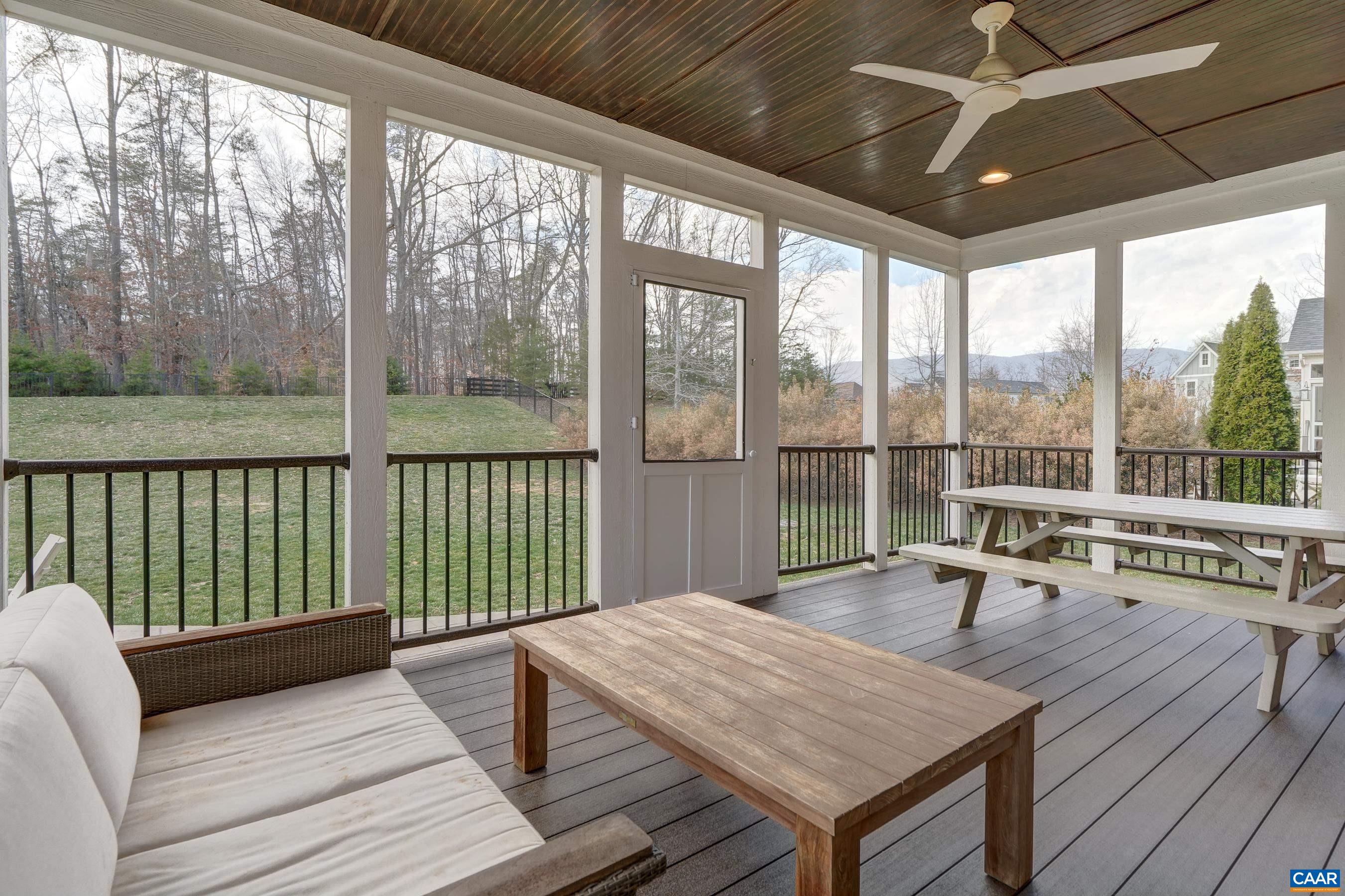 Enjoy the peaceful back yard from the screened in porch with speakers, ceiling fan and beadboard ceiling.
