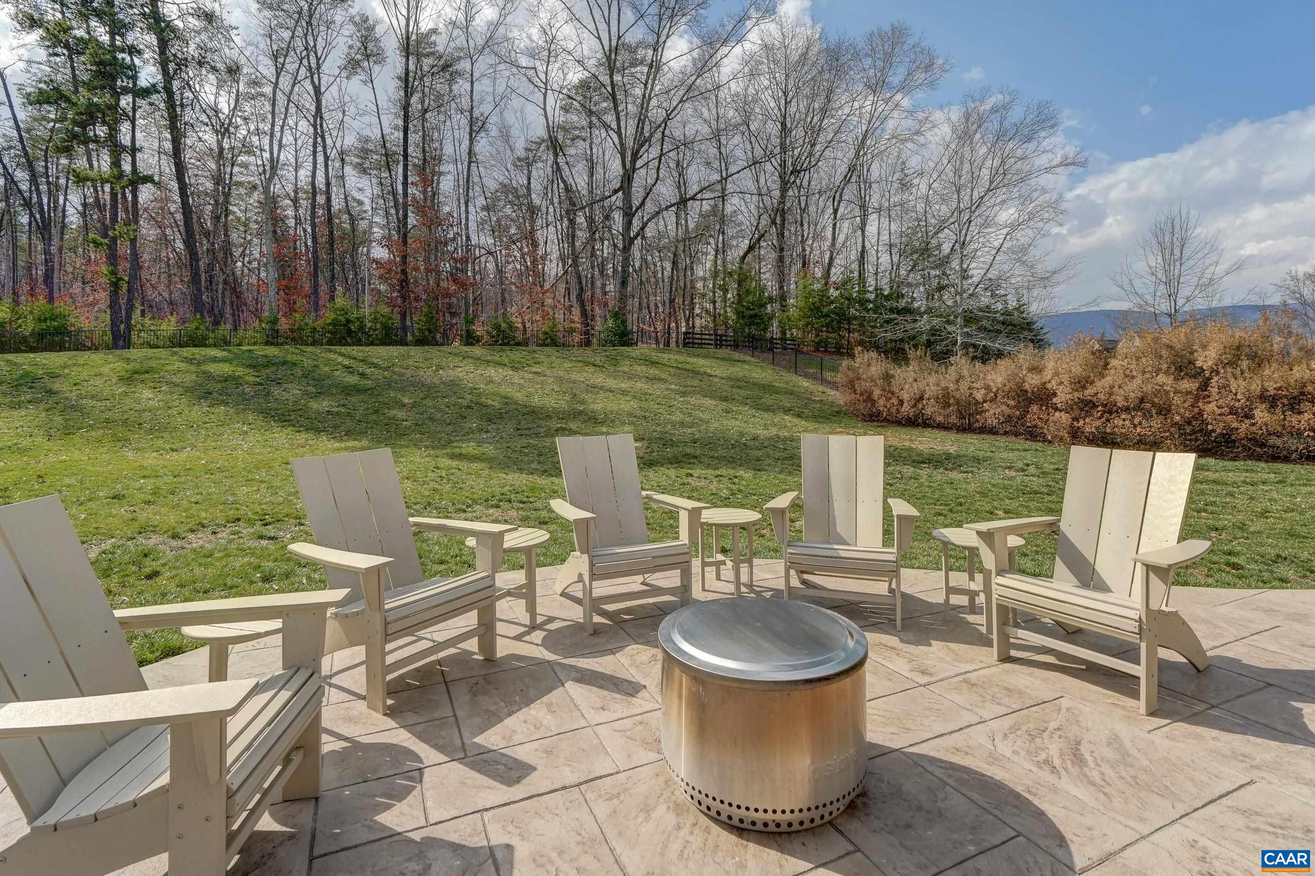 Incredible stamped concrete patio features space for a fire-pit, plus a plumbed gas line for convenient grilling!