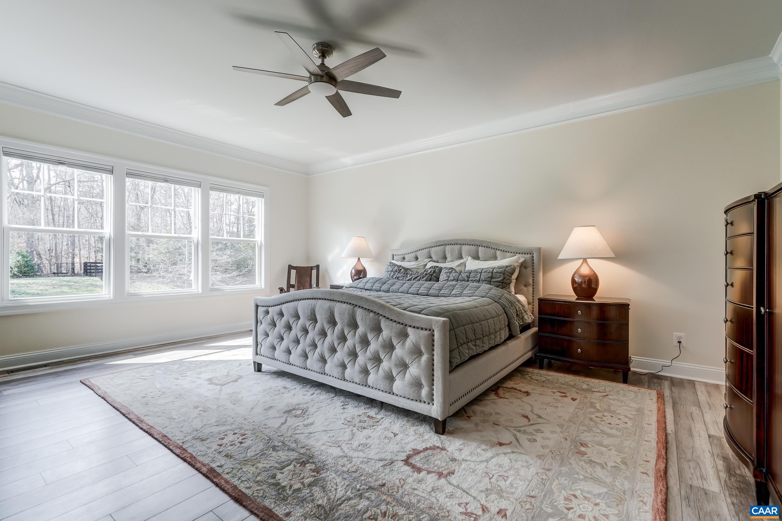 Tranquil bedroom with remote controlled ceiling fan.