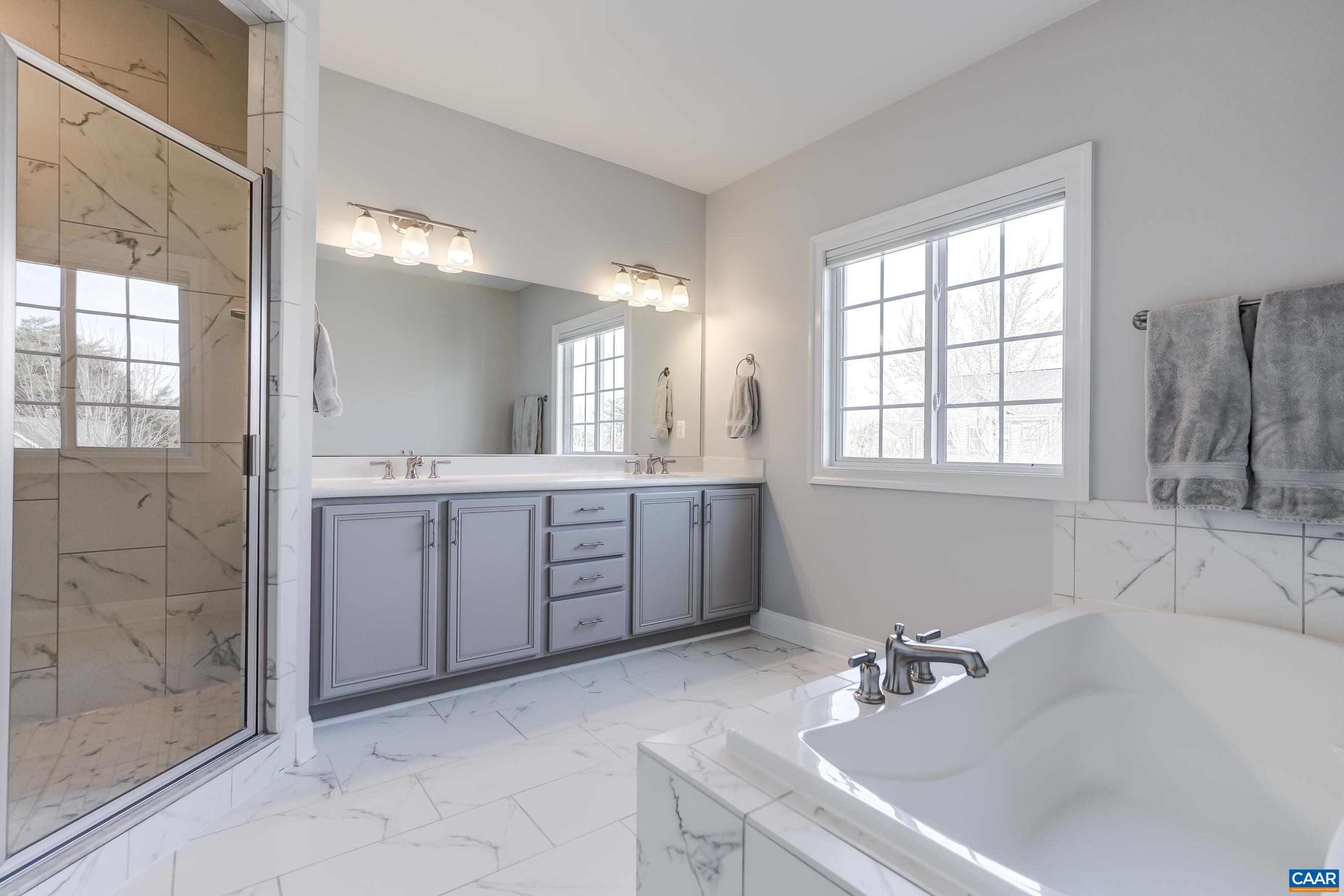 Beautiful bathroom features double sink vanity, soaking tub and separate shower.
