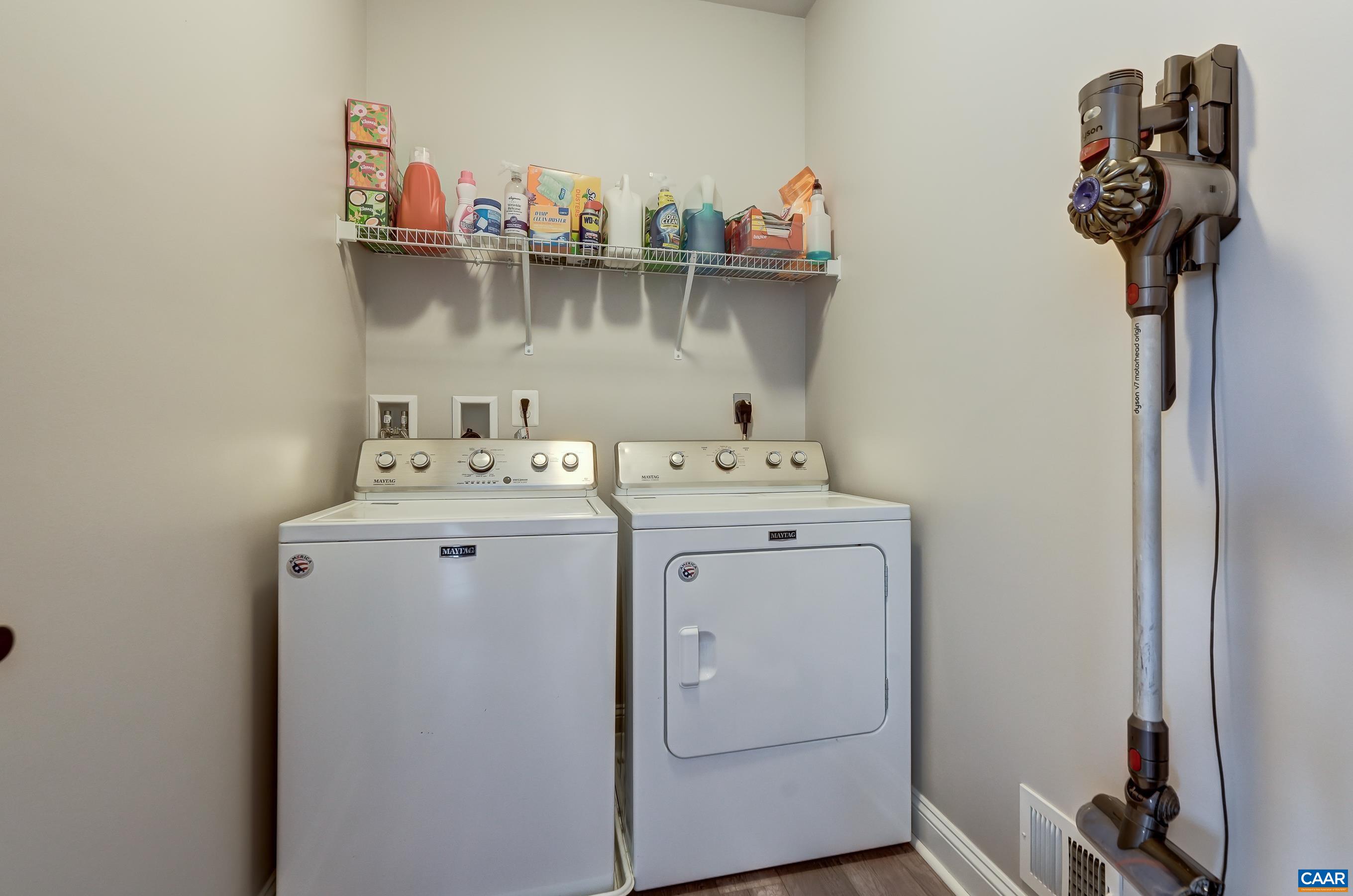 Second floor laundry room features HE top loading washer and dryer.