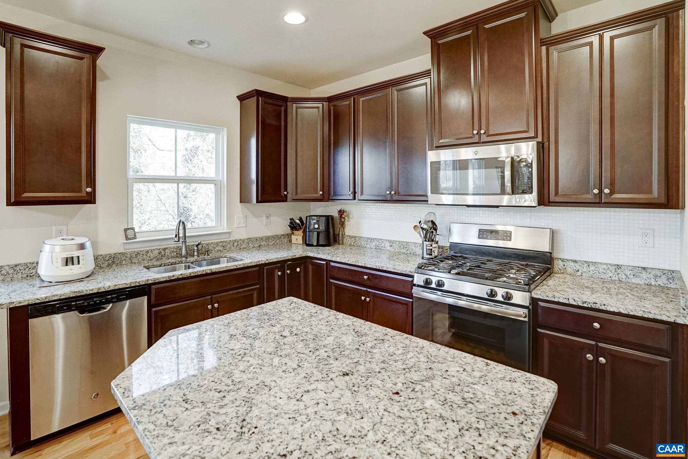 Solid wood cabinets in the kitchen offer plenty of storage!