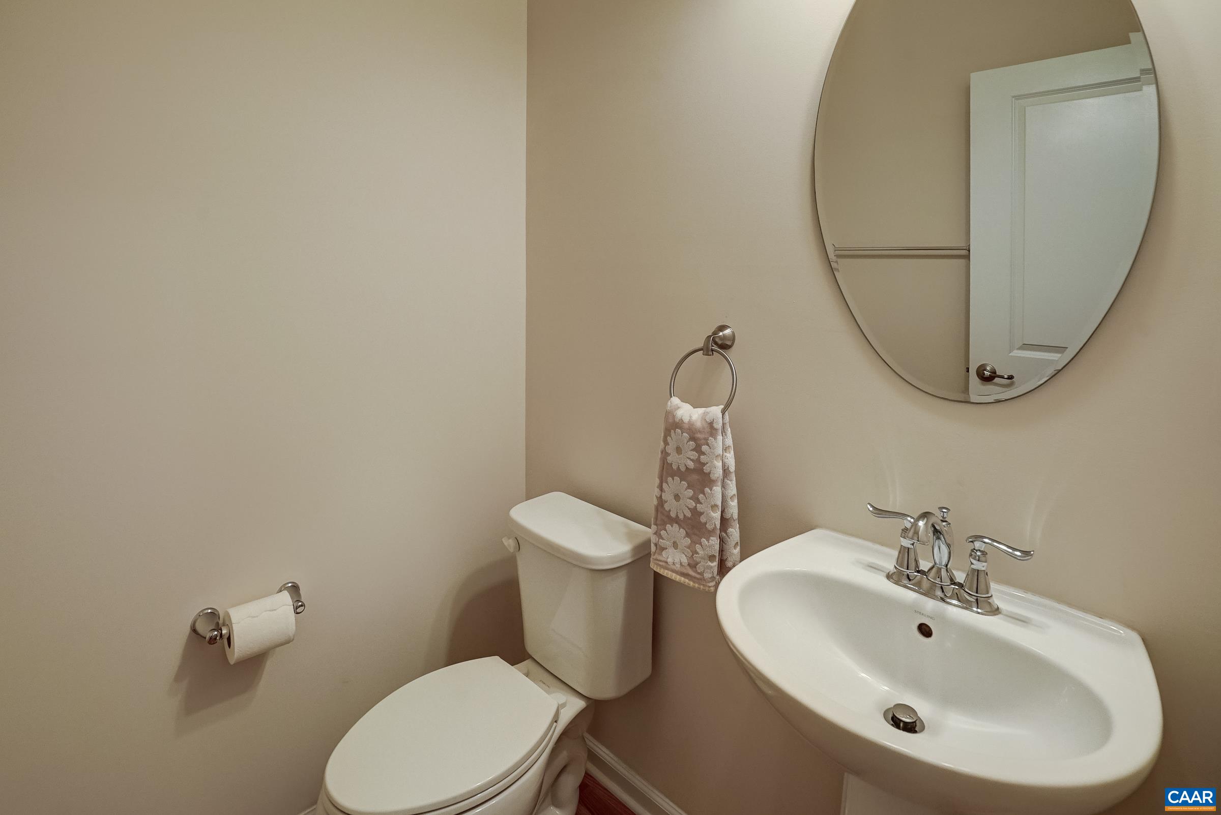 Main level powder room features pedestal sink and motion sensor lighting.