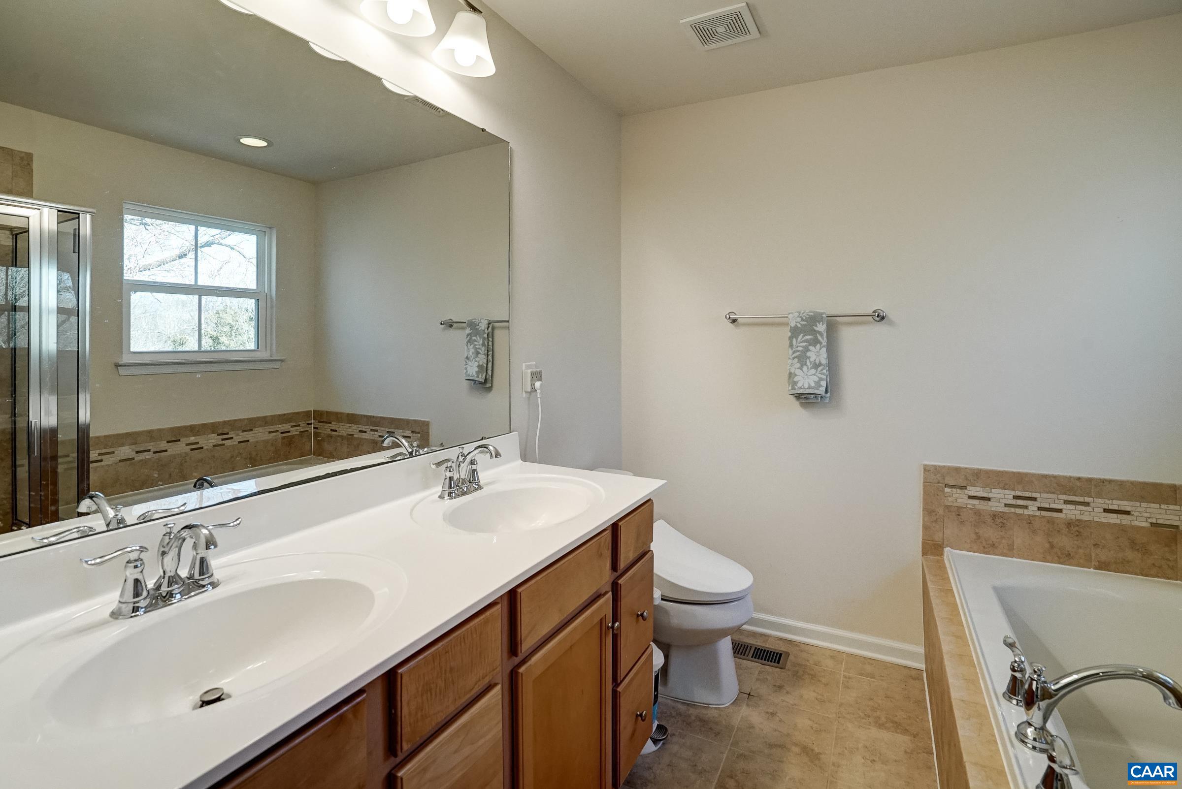 Primary bathroom with soaking tub and separate shower.