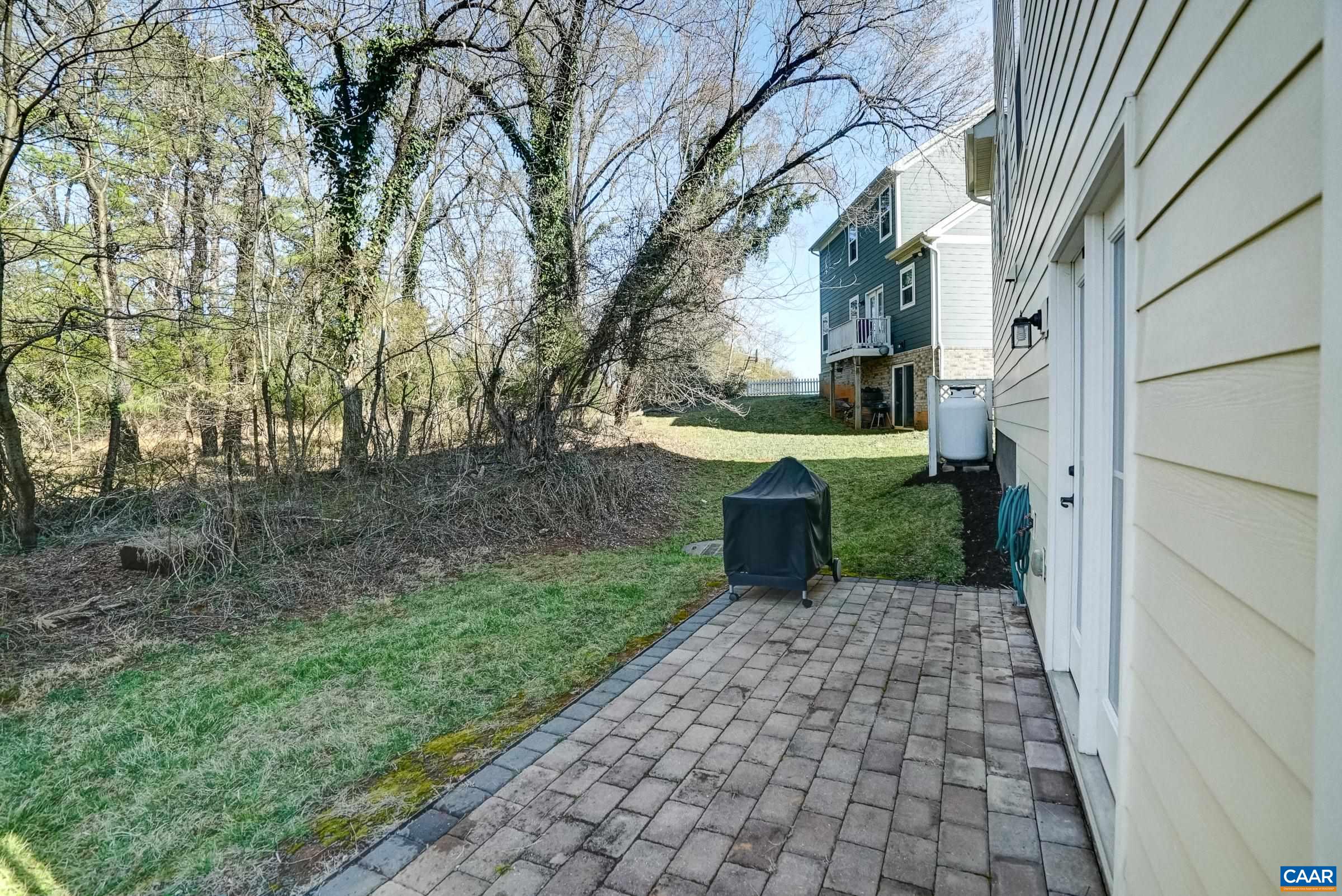 Patio at rear of home with space for grilling.
