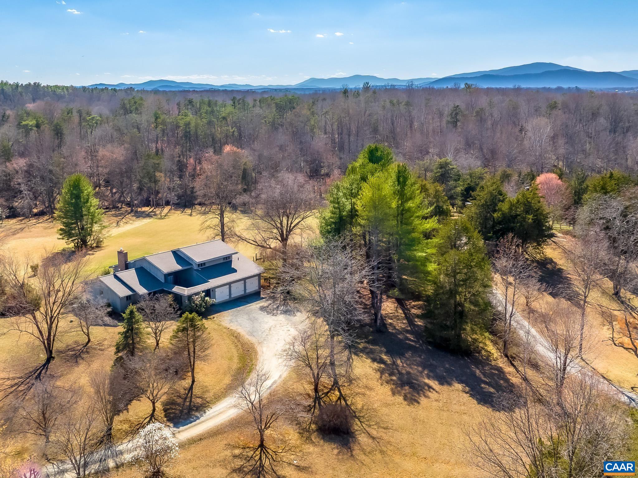 Elegant Country Estate on 5 nicely groomed Acres with Elk Run Creek Frontage.