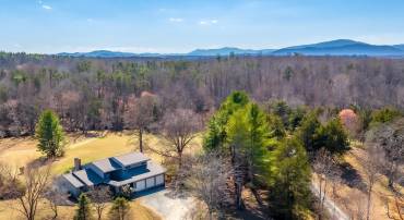 Elegant Country Estate on 5 nicely groomed Acres with Elk Run Creek Frontage.