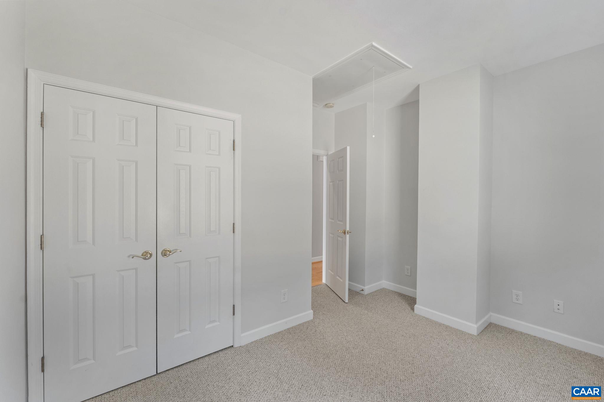 Additional bedroom with large closet and attic access.