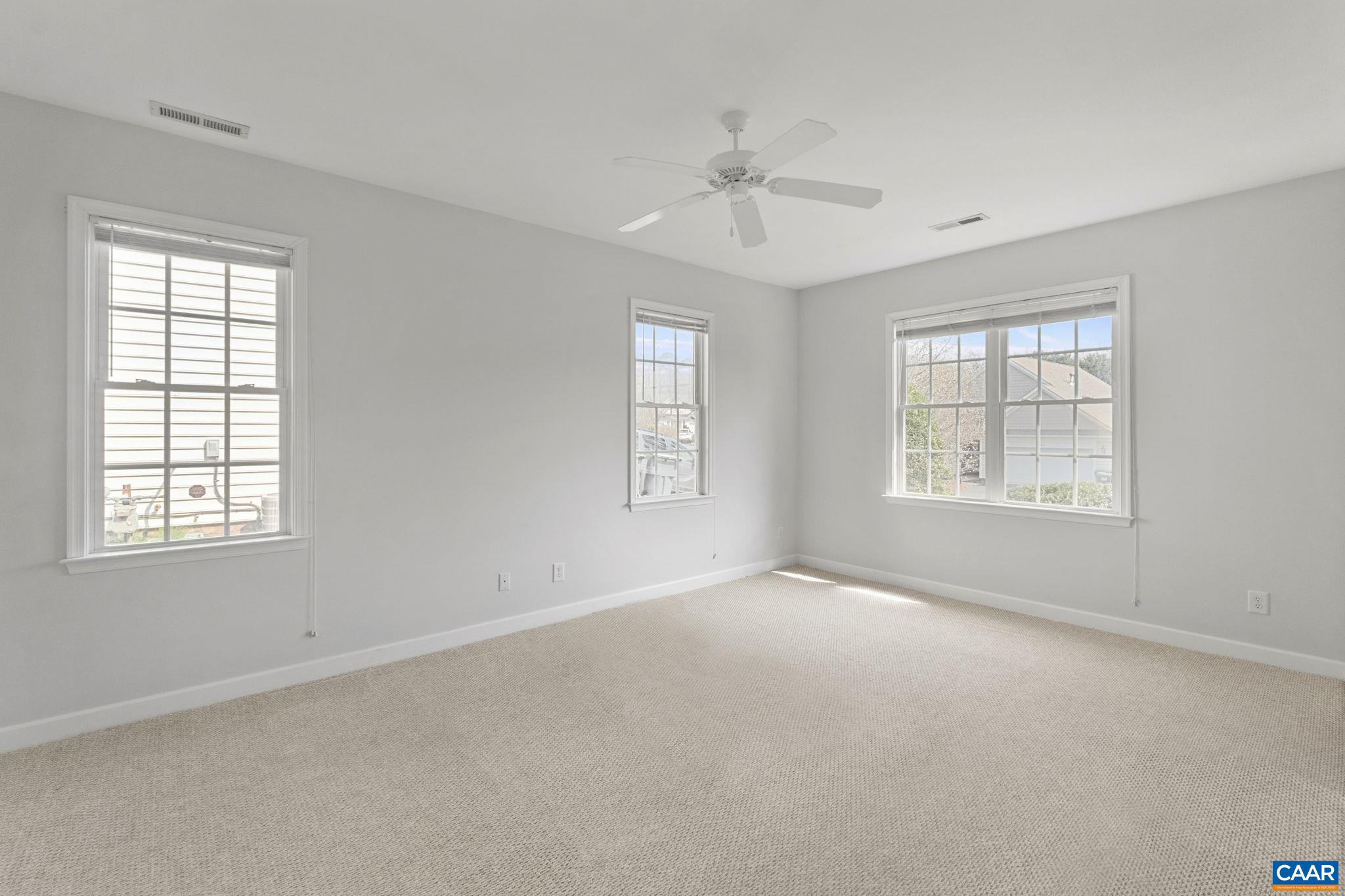 Primary bedroom is large and bright.