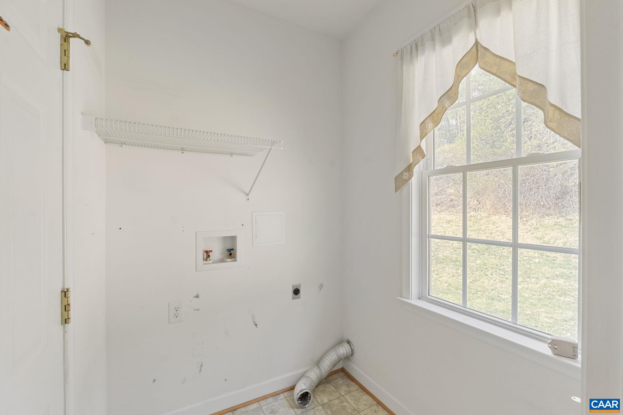 Laundry room behind kitchen.