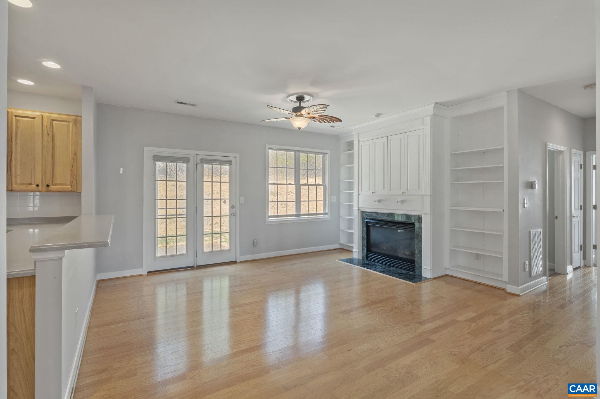 Open living area with hardwood floors, gas fireplace and built-ins.