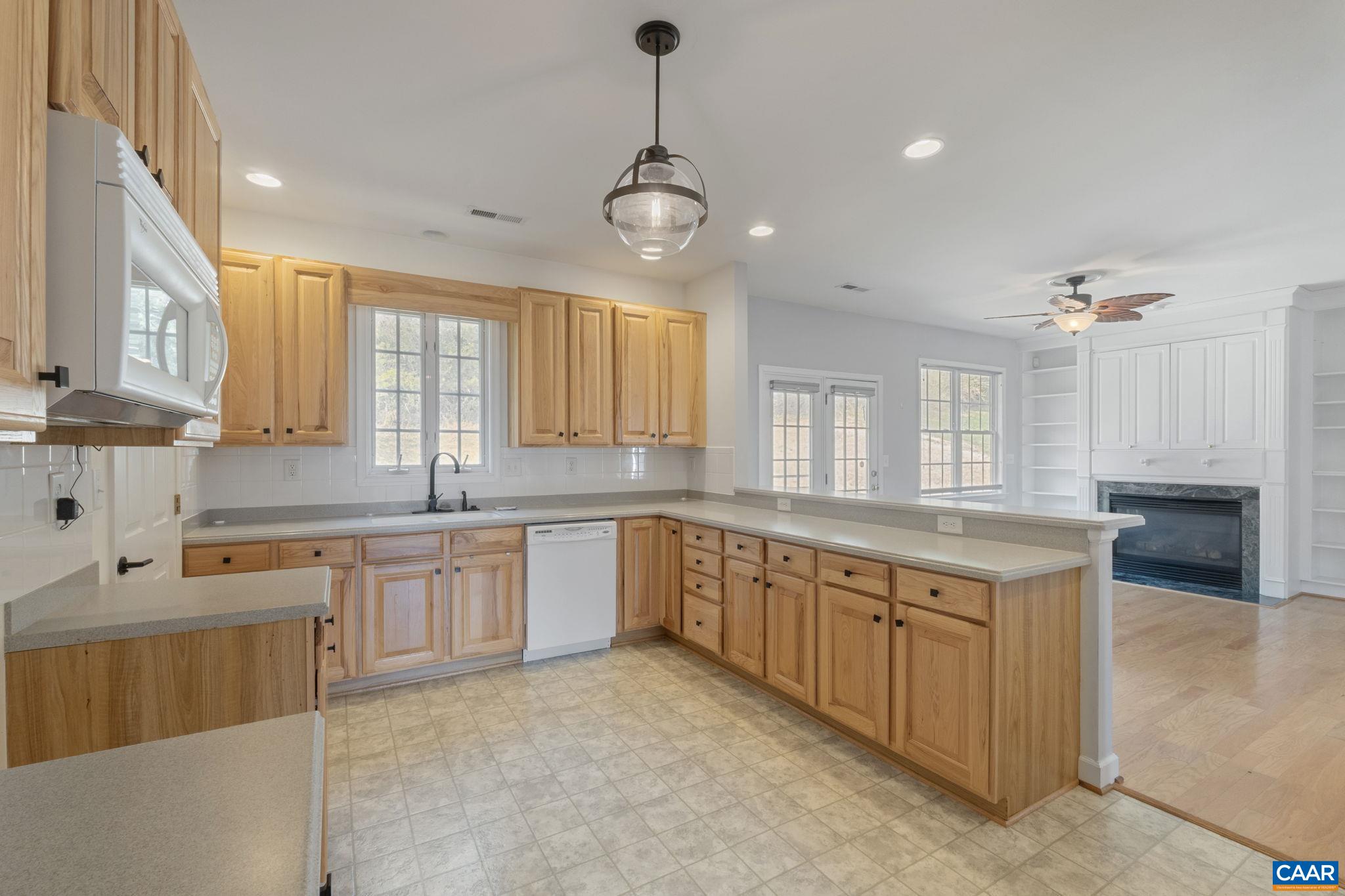 Kitchen with wood cabinets and solid surface counters.